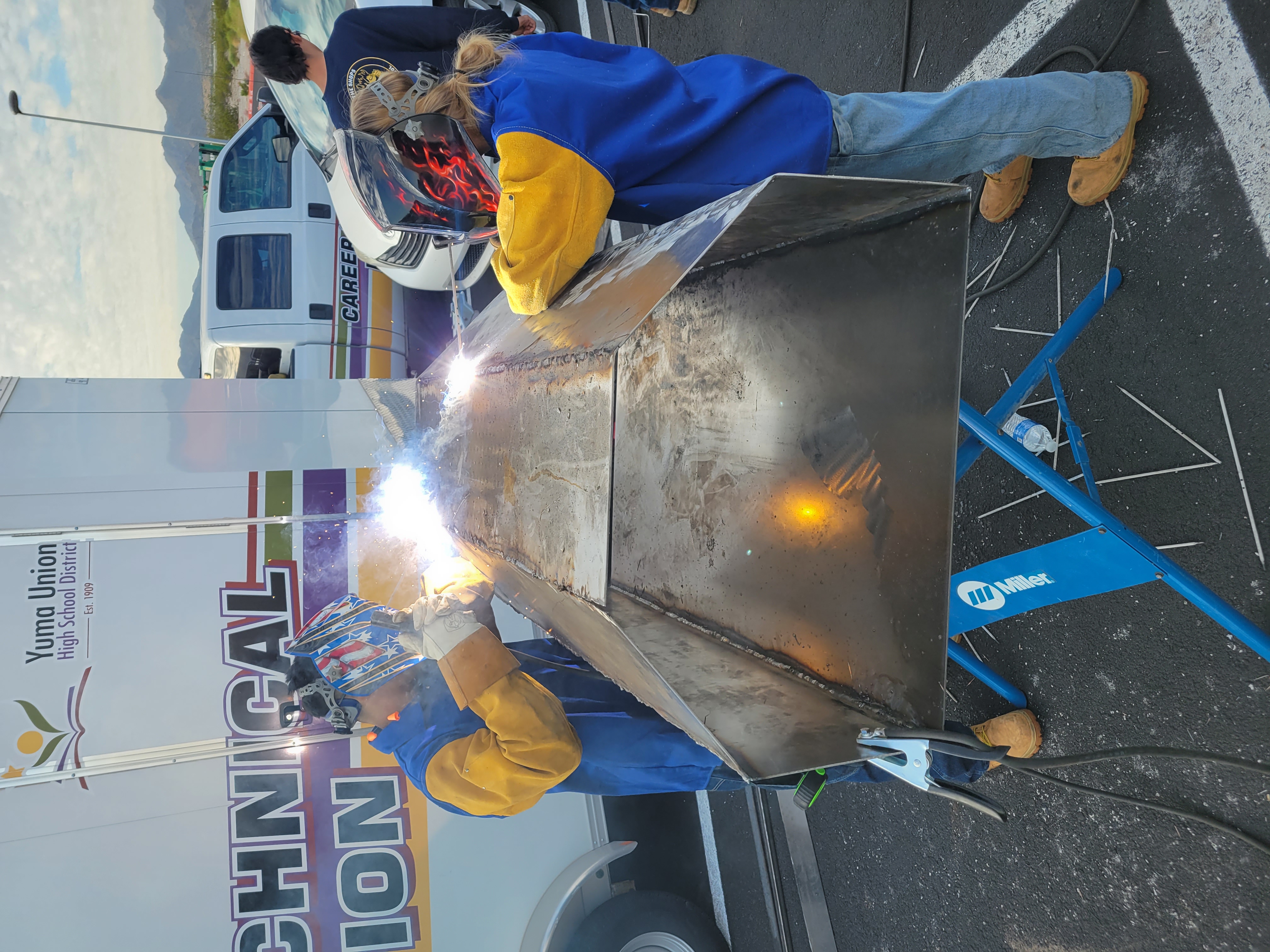 Two PHS Students welding a grill cover for a competition