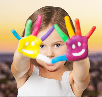 girl with happy face painted hands
