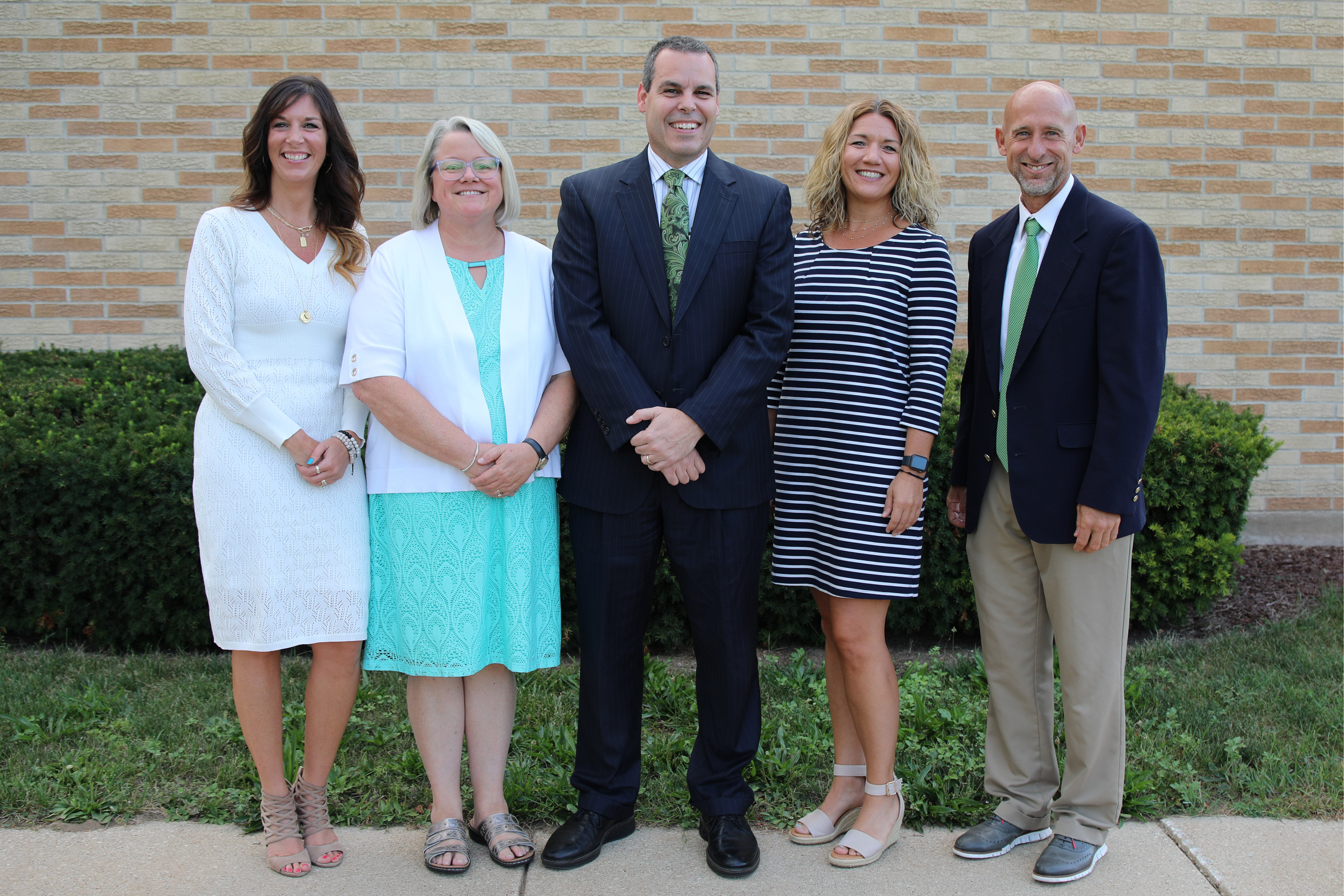 Five school board members pose for a picture
