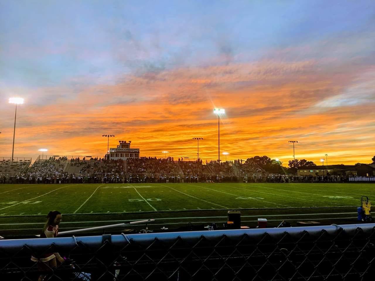 A sunrise over an athletic field