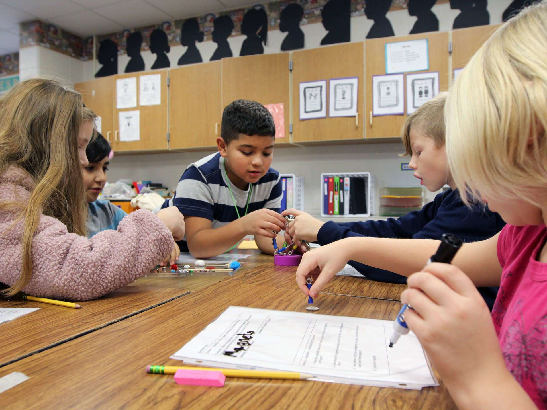 Students at a table working together on a project