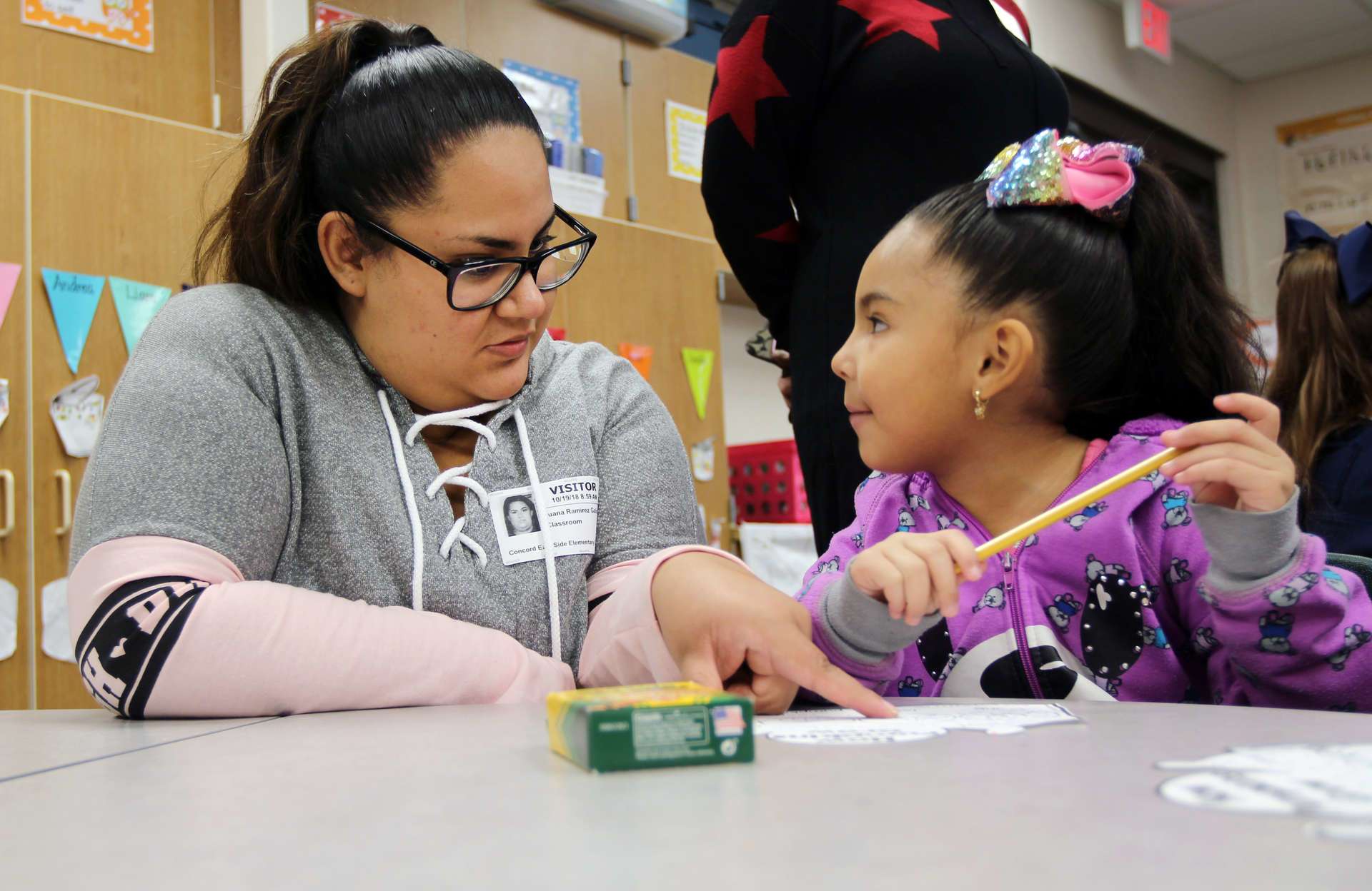 Parent and student sitting together at a table