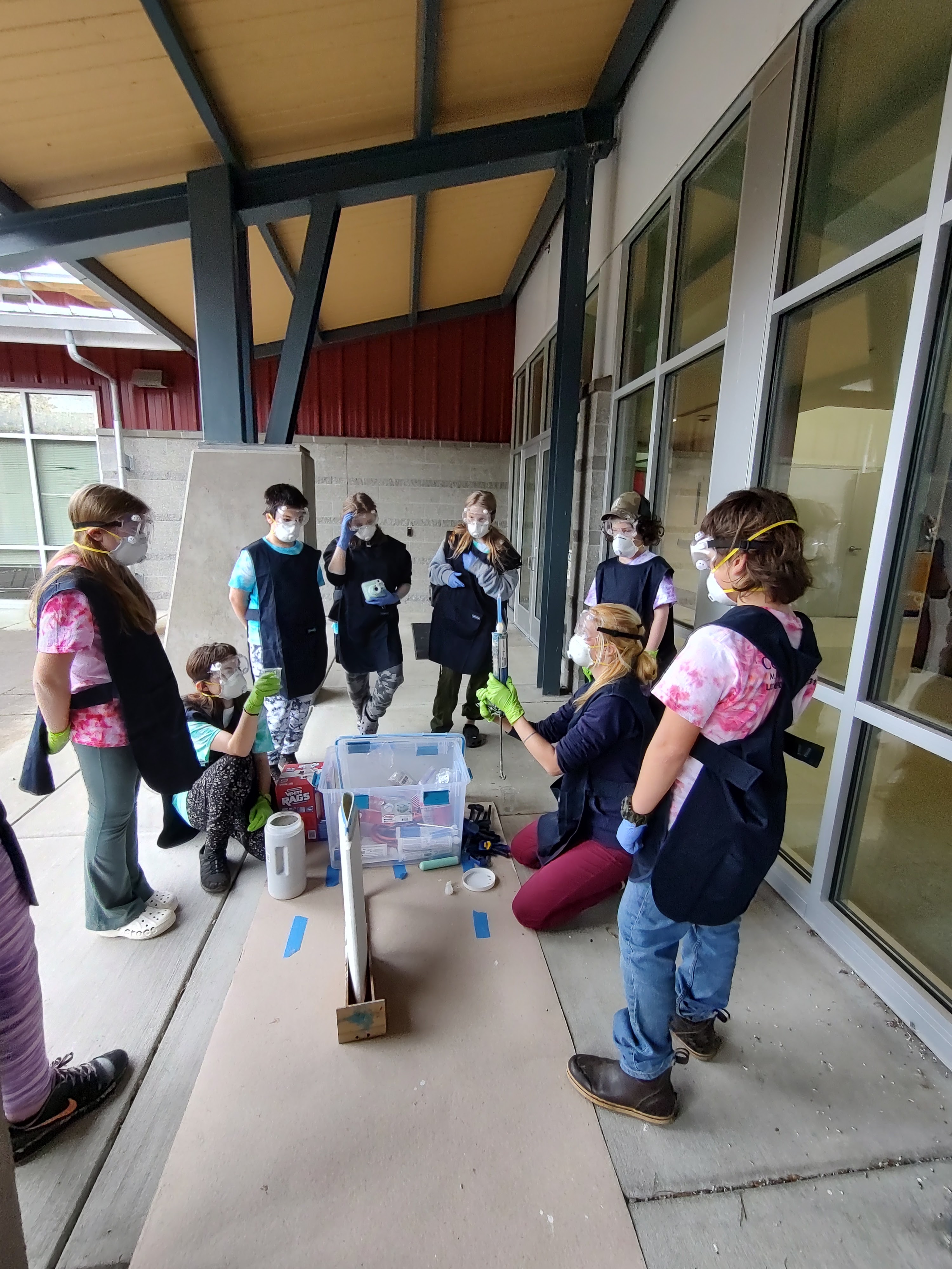 Students wearing goggles, doing a science experiment.