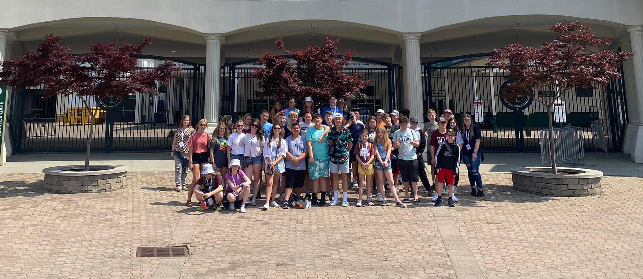 a large group of students outside of the Churchill Downs racetrack 