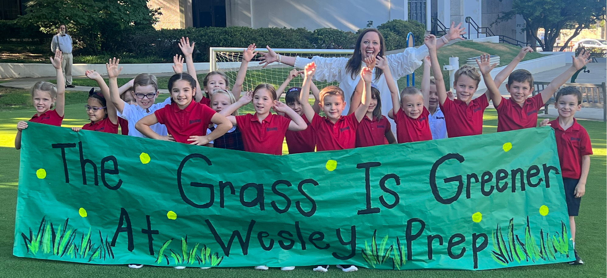 Meg Fahrenbrook with students on new turf