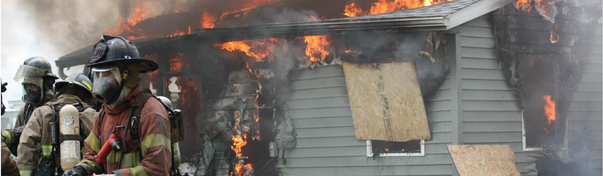 Fire Volunteers in front of a burning house