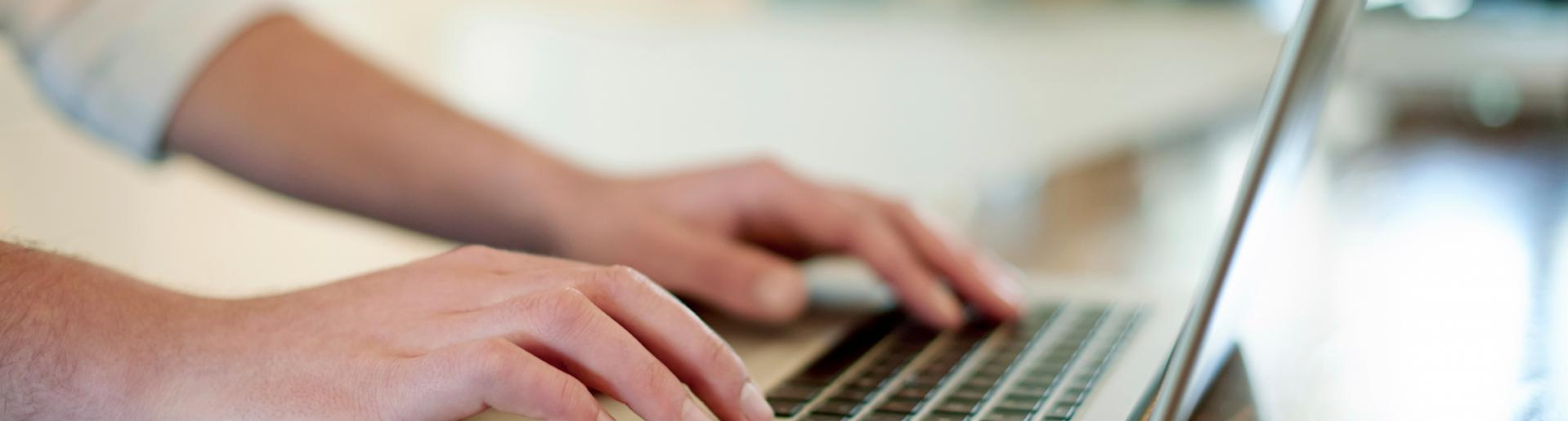 Stock photo of someone typing on a laptop