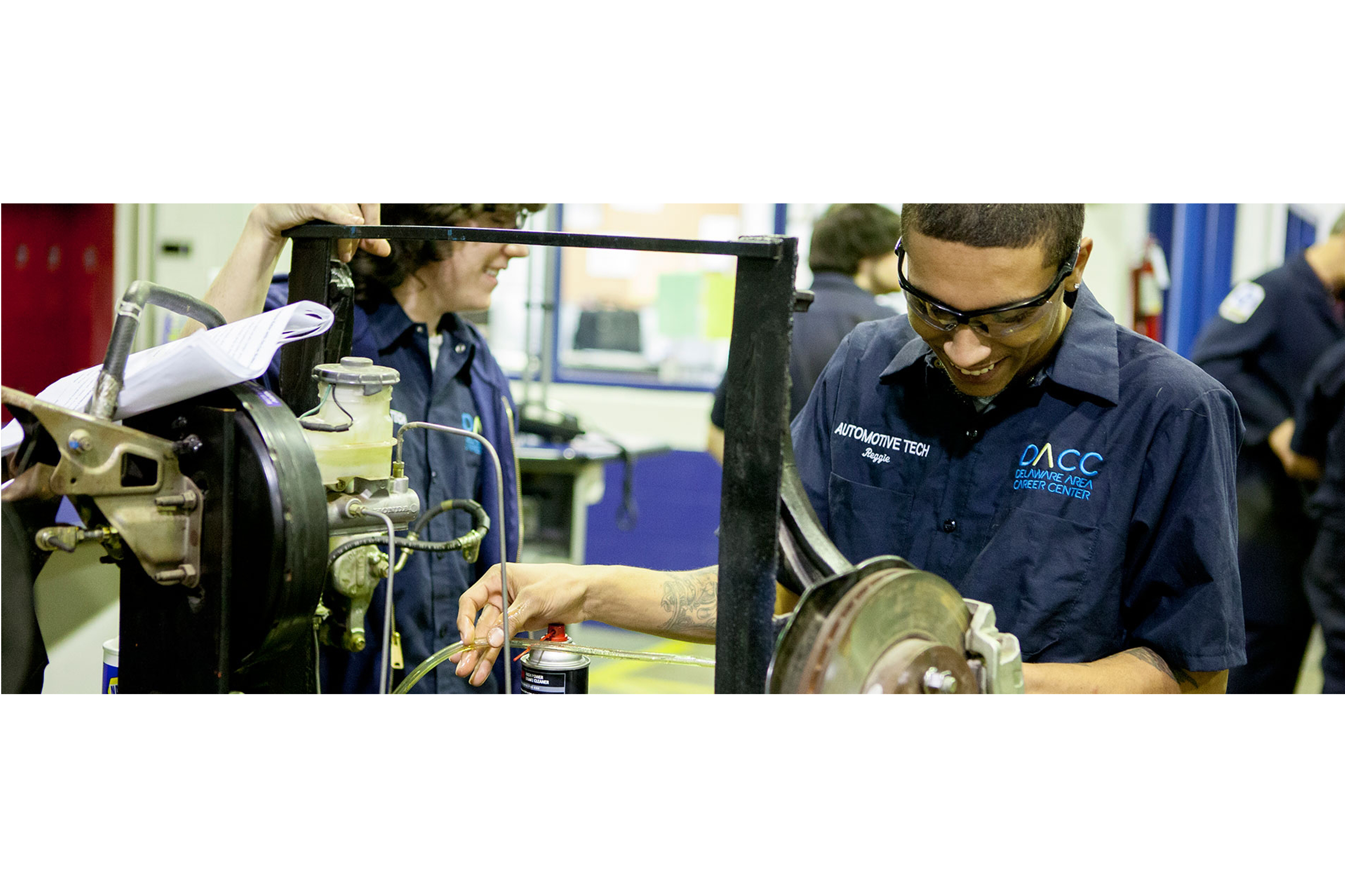 automotive students practice with car