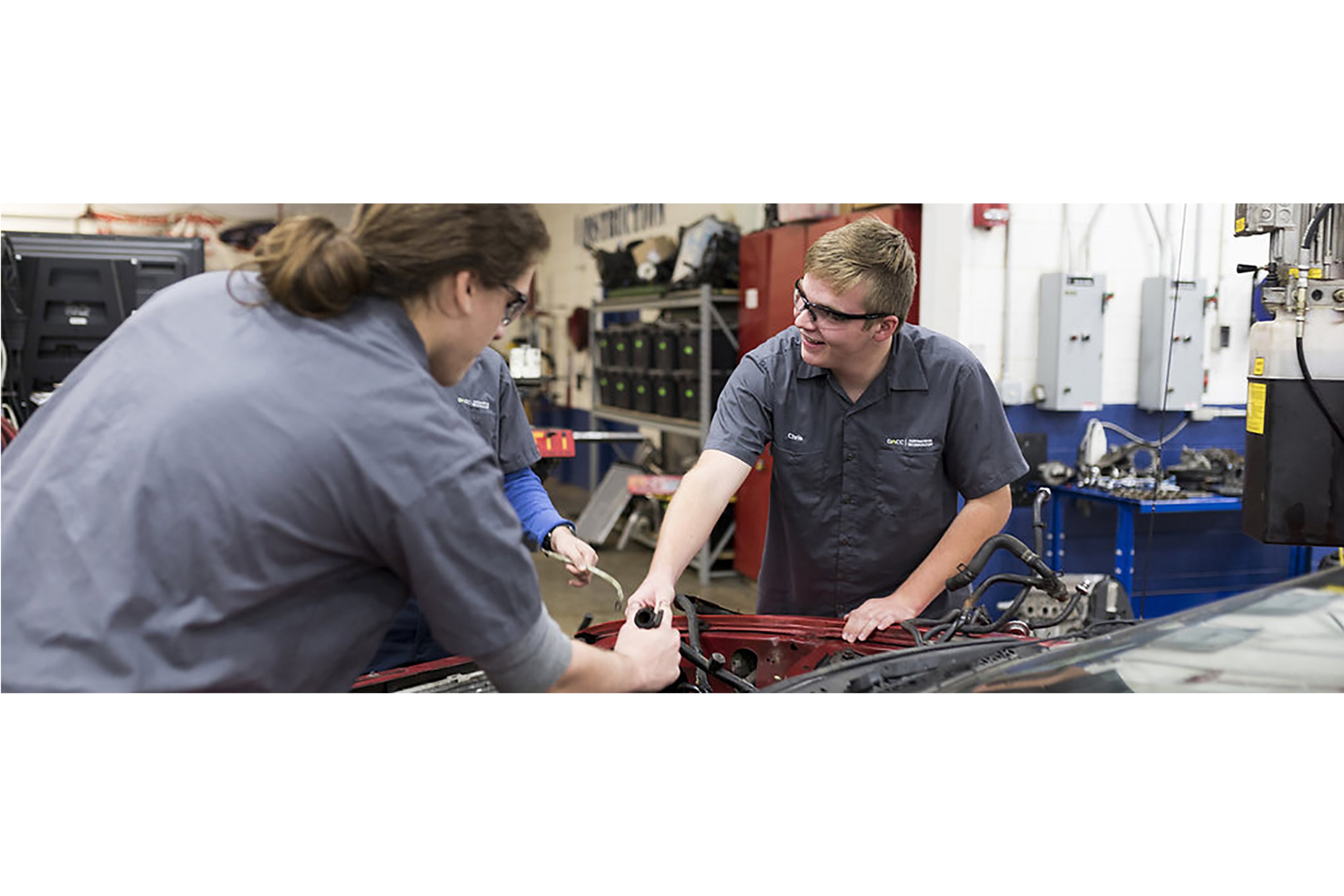 automotive students practice with car