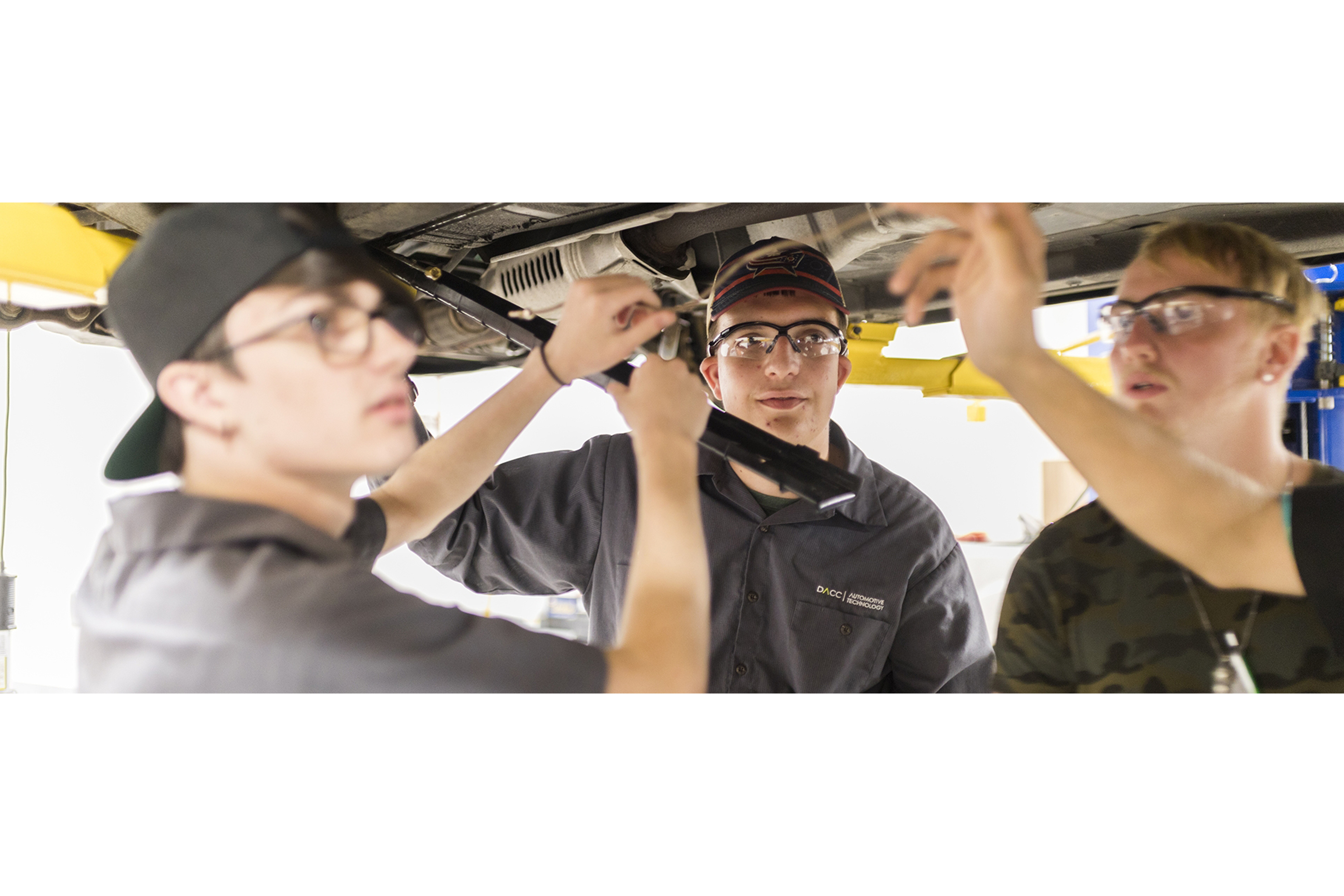 automotive students practice with car