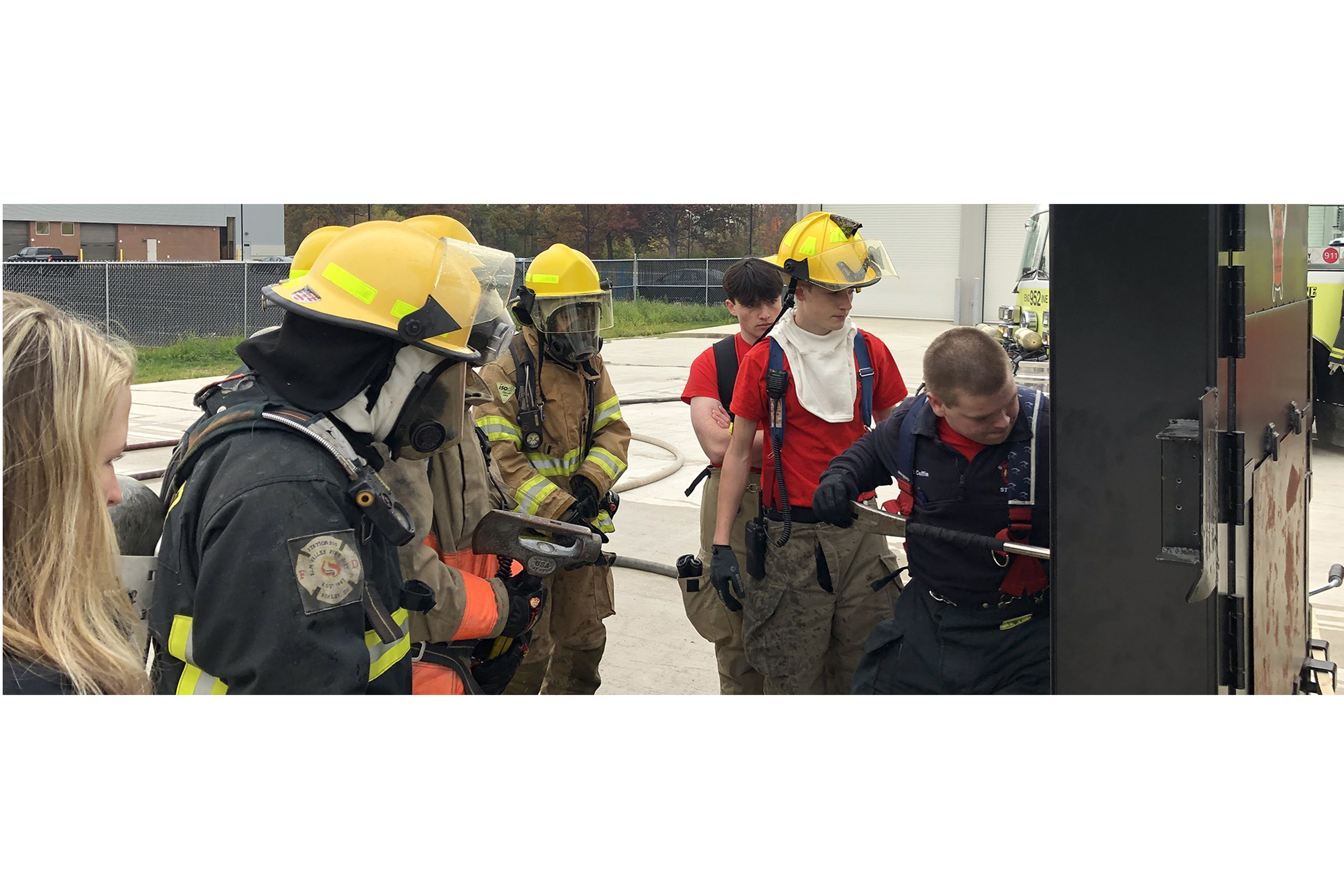 group of student fire fighters watching a demo