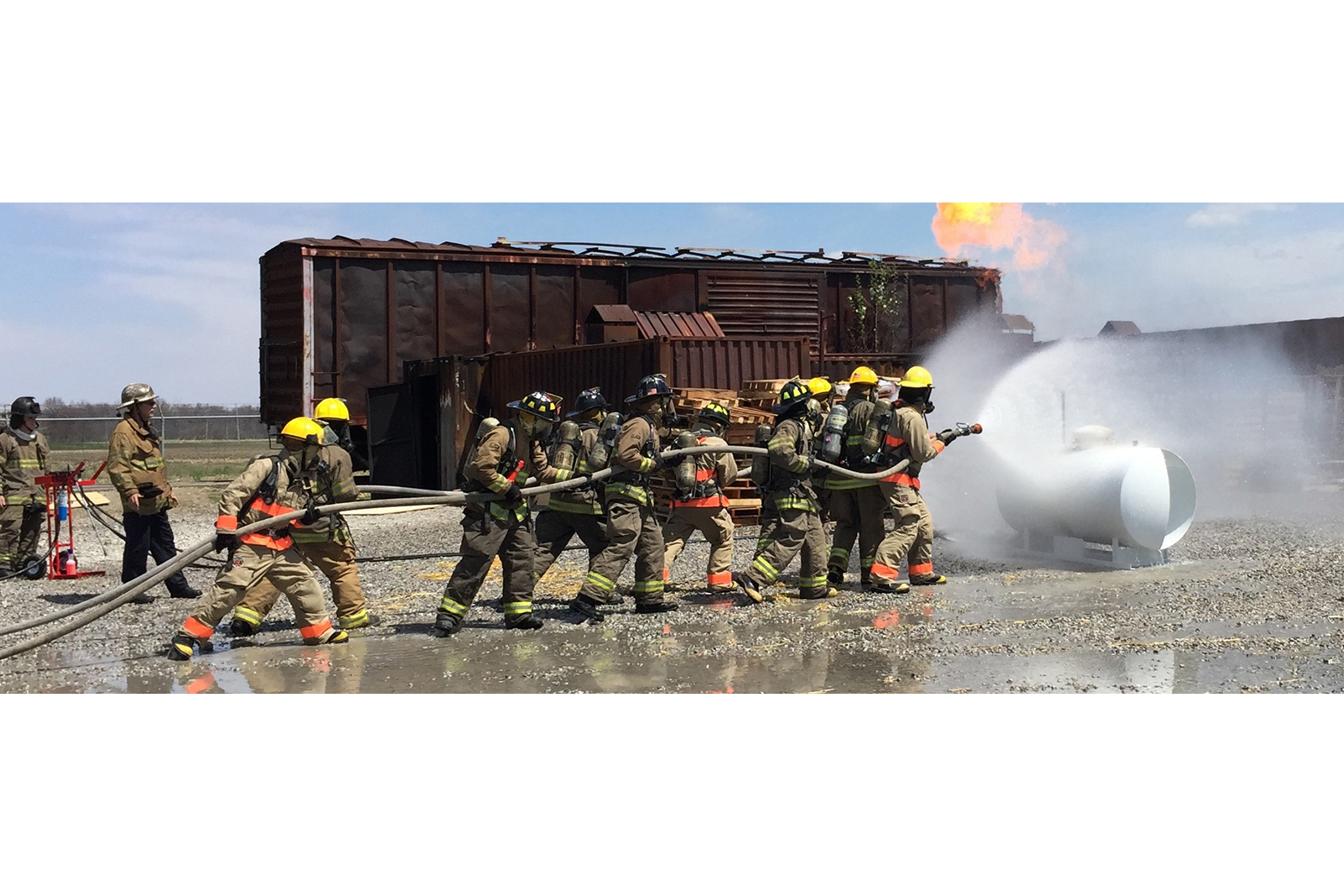 students fire fighters practicing with hose