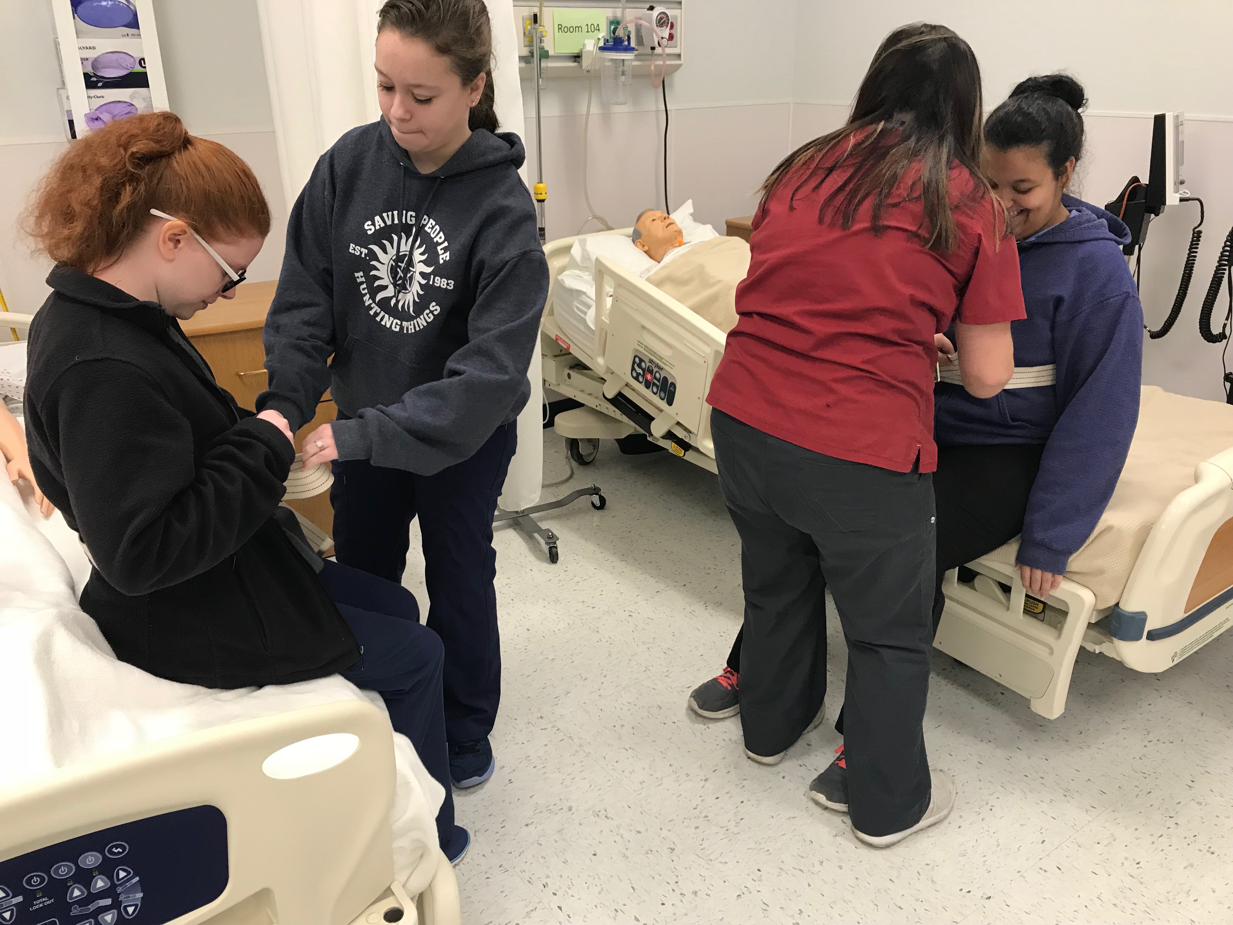 Students practicing health care skills