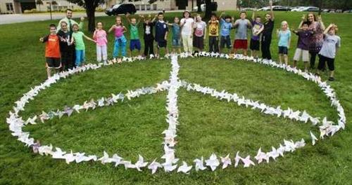 Pinwheels in the grass in the shape of a peace sign