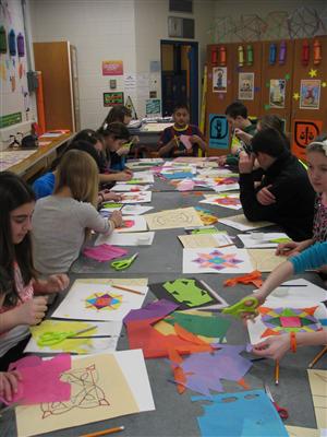 Students designing Rangoli artwork