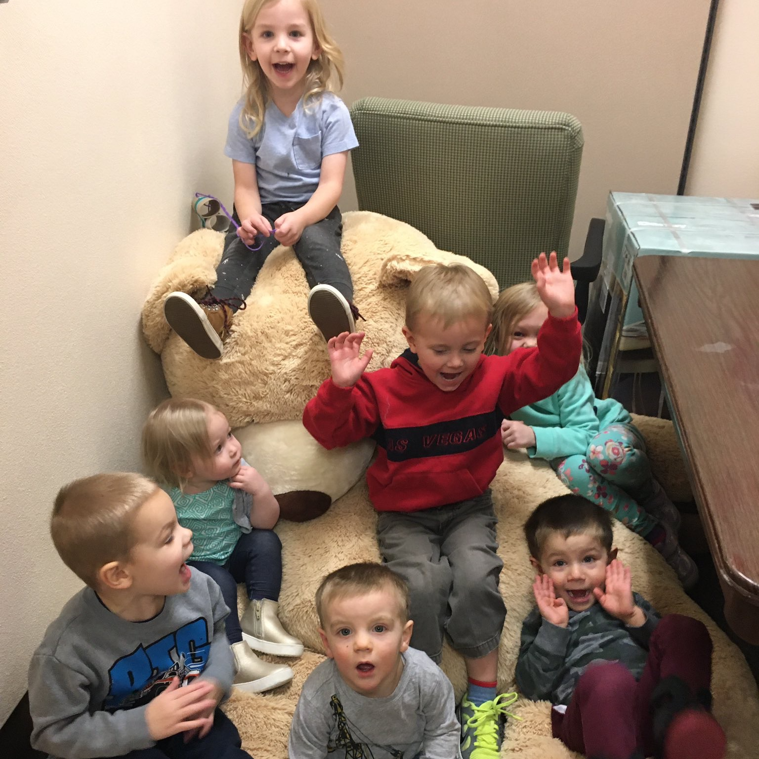 Students on big teddy bear