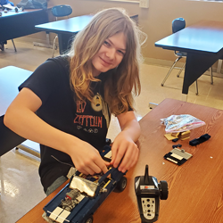 student working on remote control vehicle