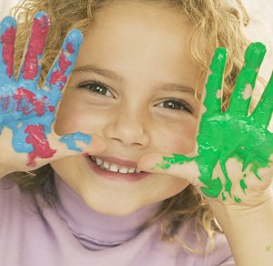 Young girl with paint on her hands