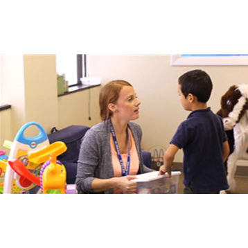 Teacher talking to young student