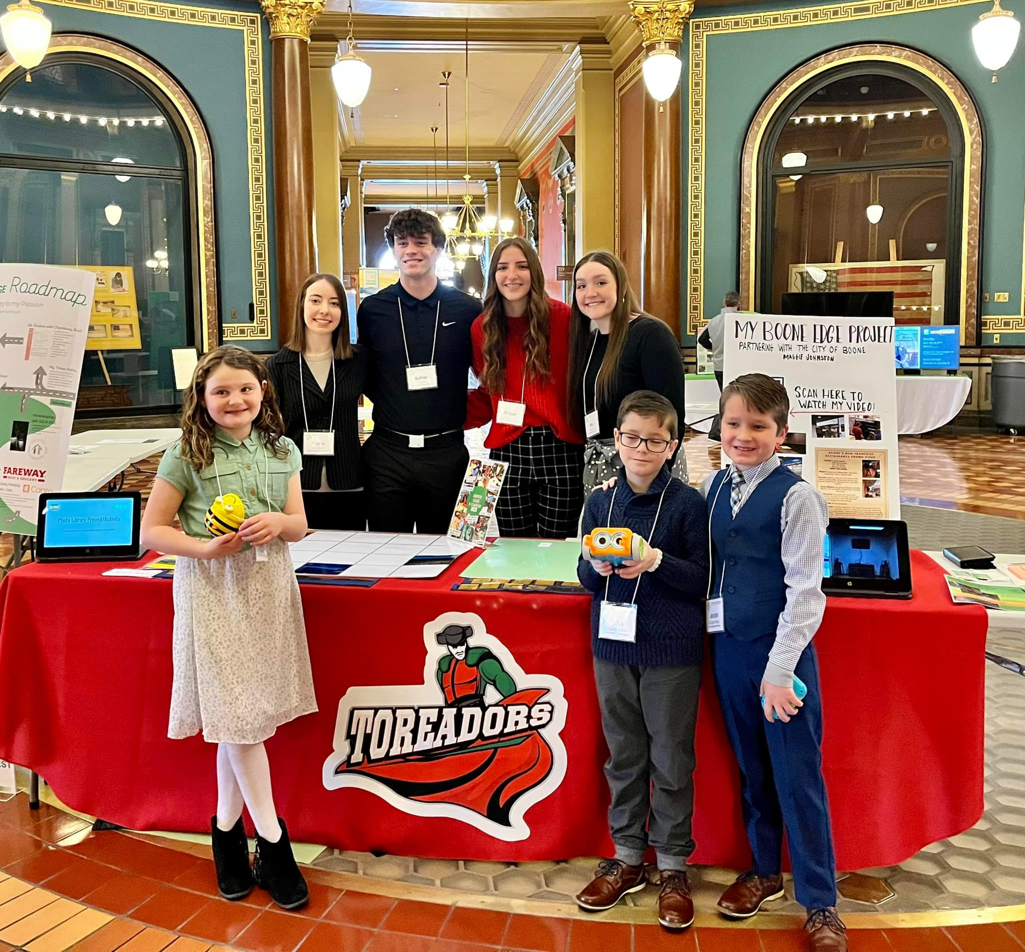 Students at the Capitol  at a boone toreador table representing the school 