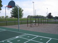 The playground includes an area for basketball, four square, and swings.