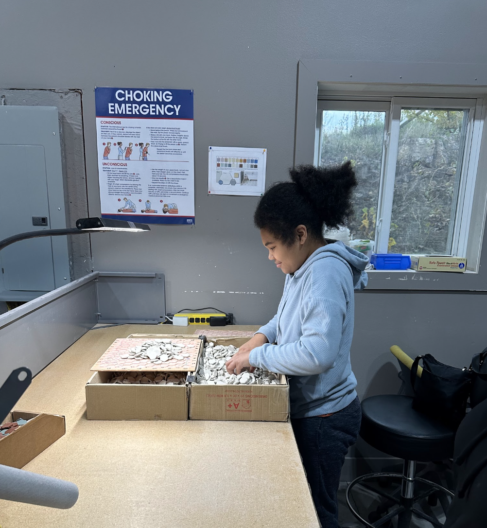 student helping fold boxes