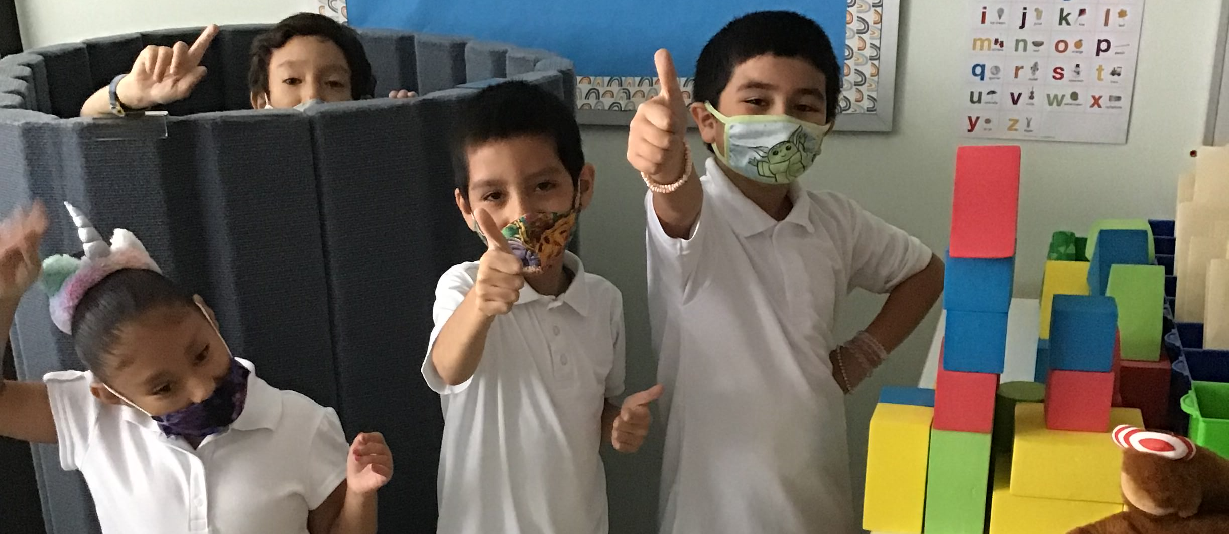 students giving thumbs up