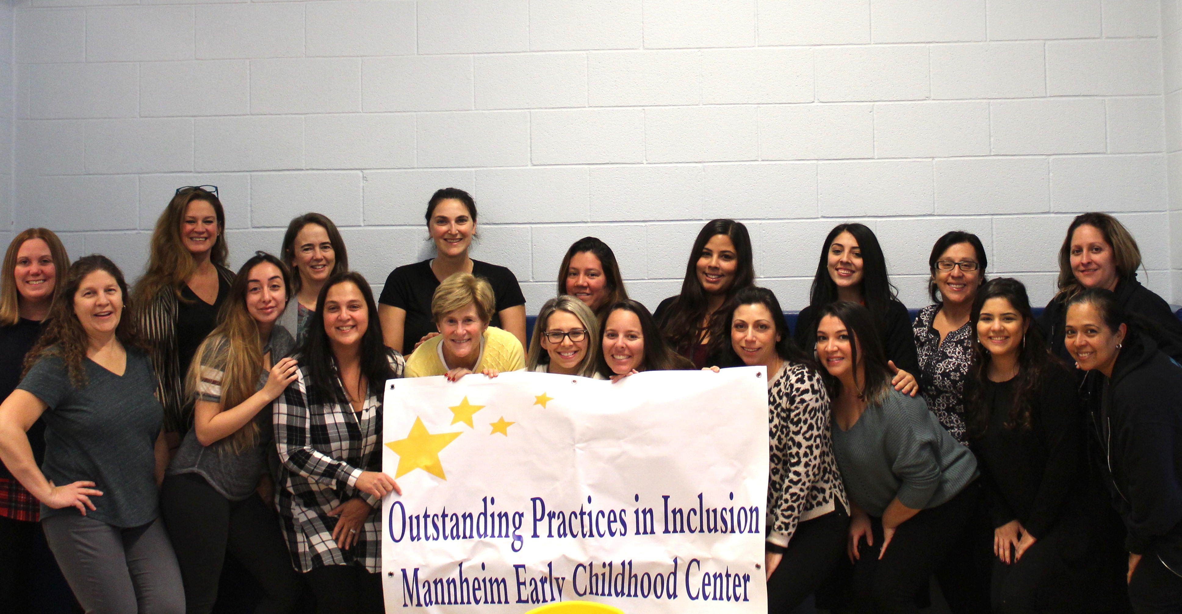 MECC staff posing with Outstanding Practices in Inclusion banner