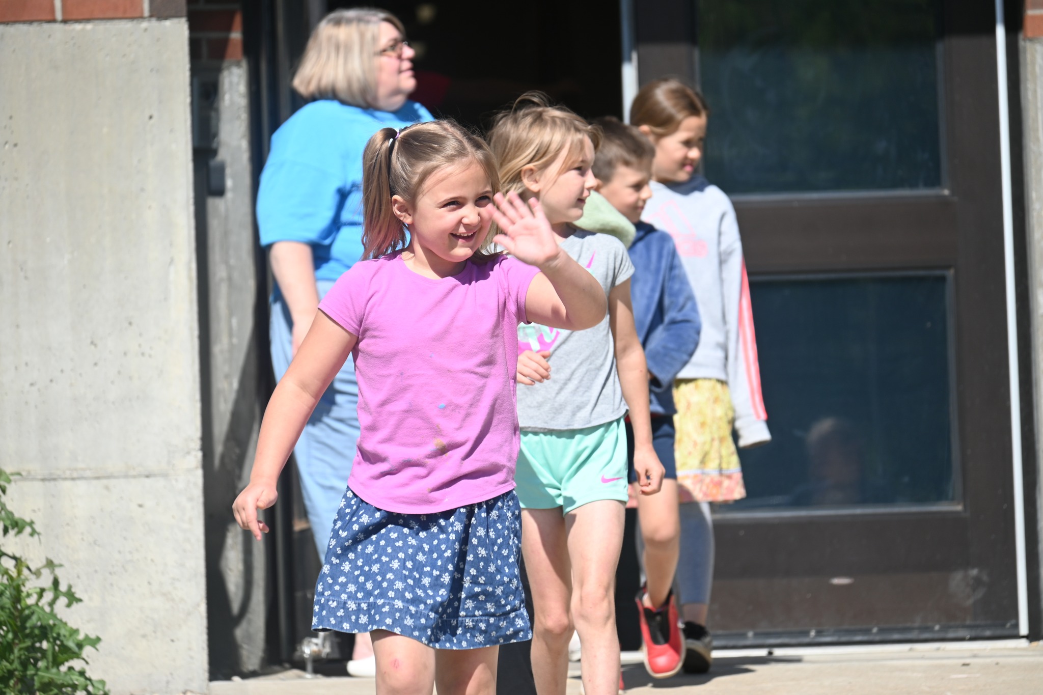 elementary students coming out of school building