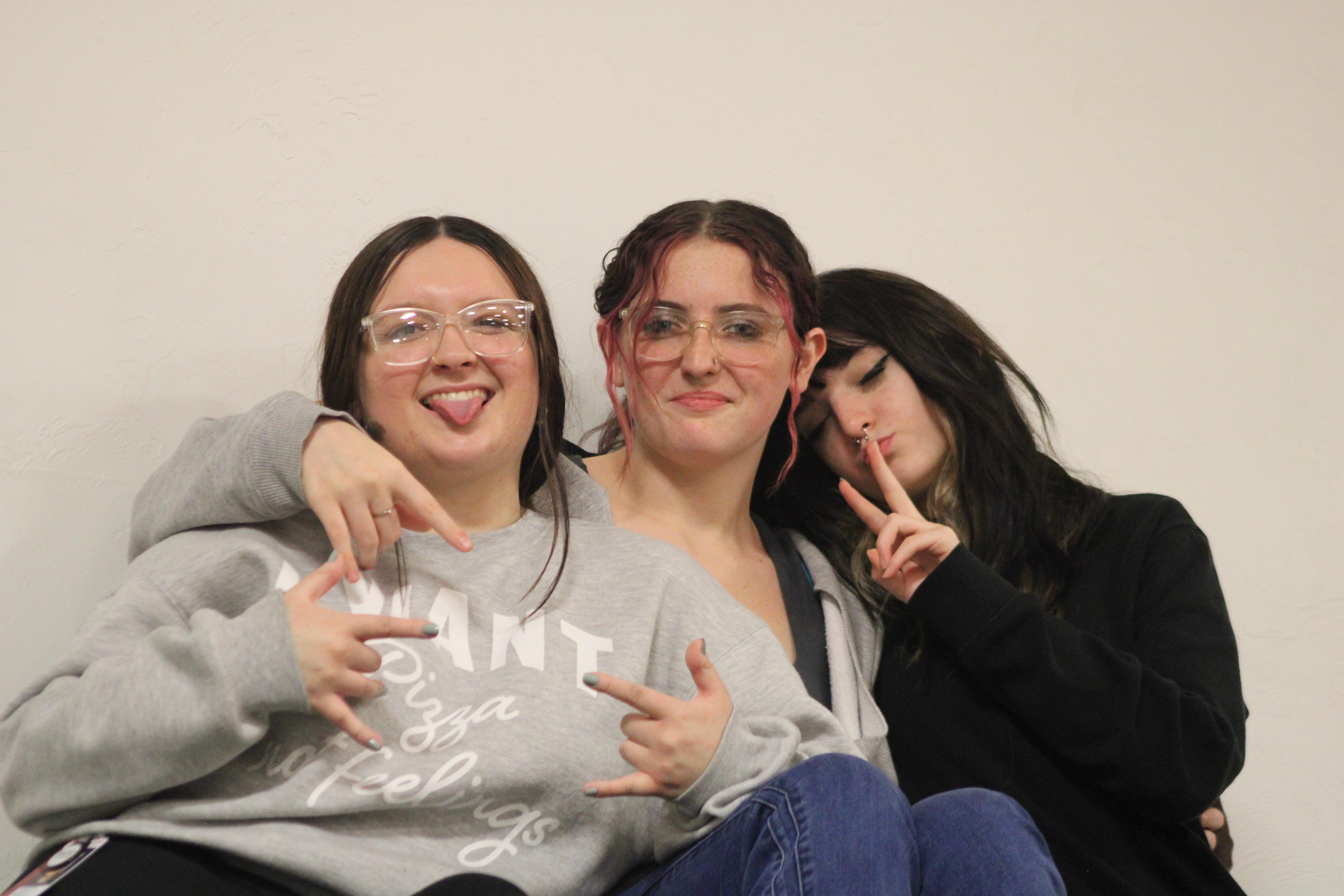 Journalism members Maddyson Marson-Compton, Raylee Blalock, and Senior Editor Calora Cain posing while covering the Homecoming game . 