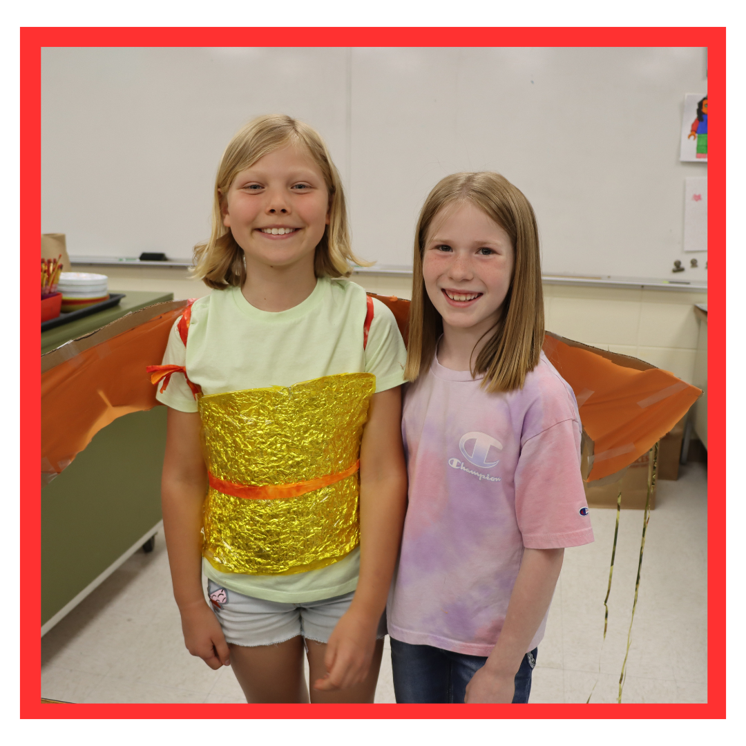 two students posing in costume 