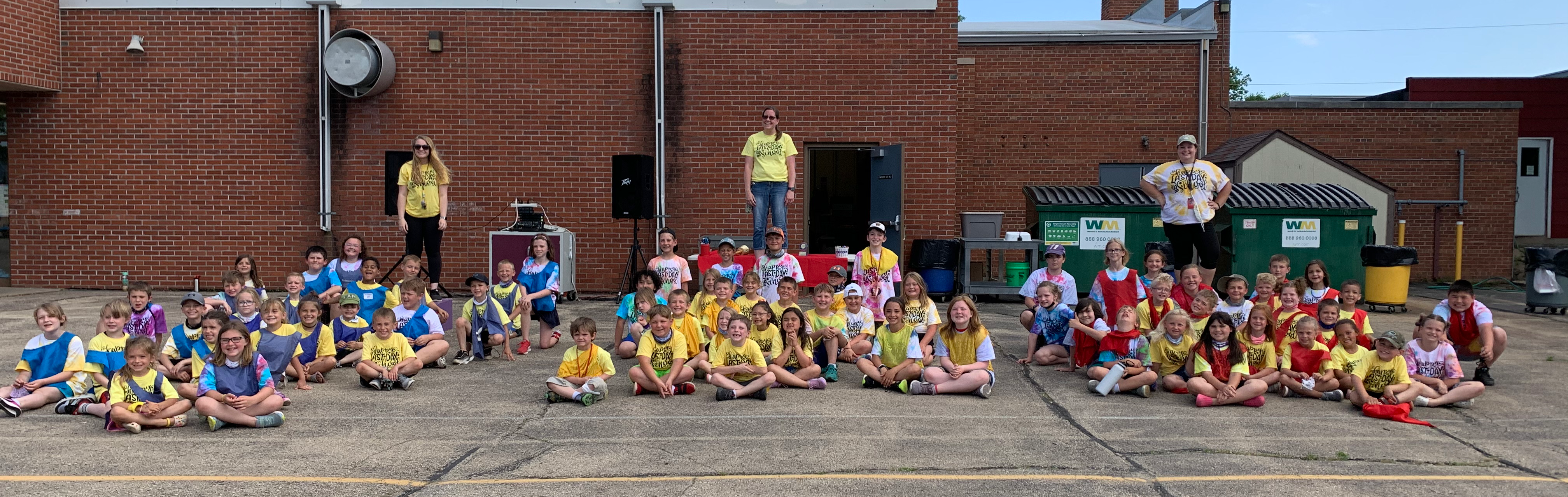 Students sitting outside of a school