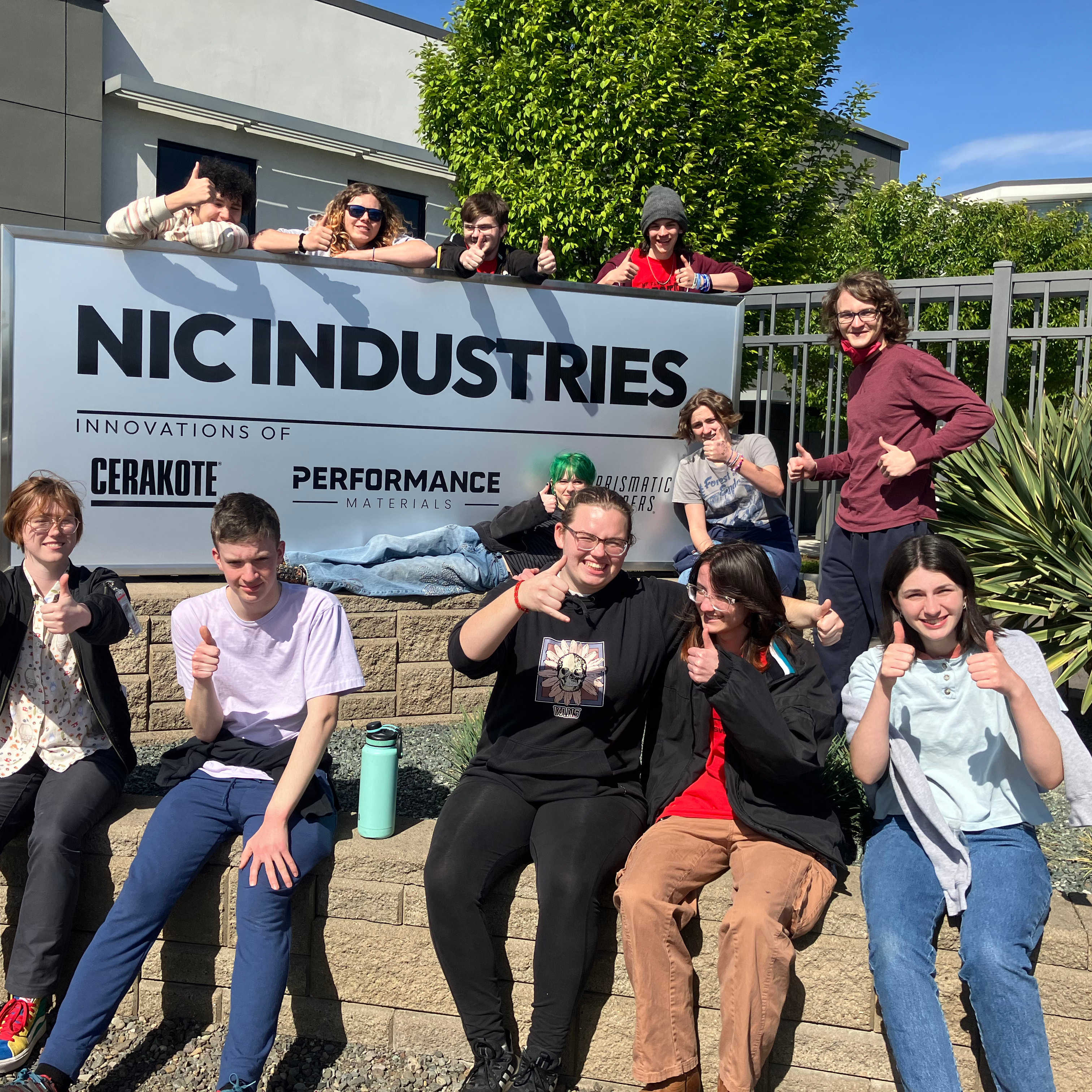 group photo pf students around sign for NIC Industries