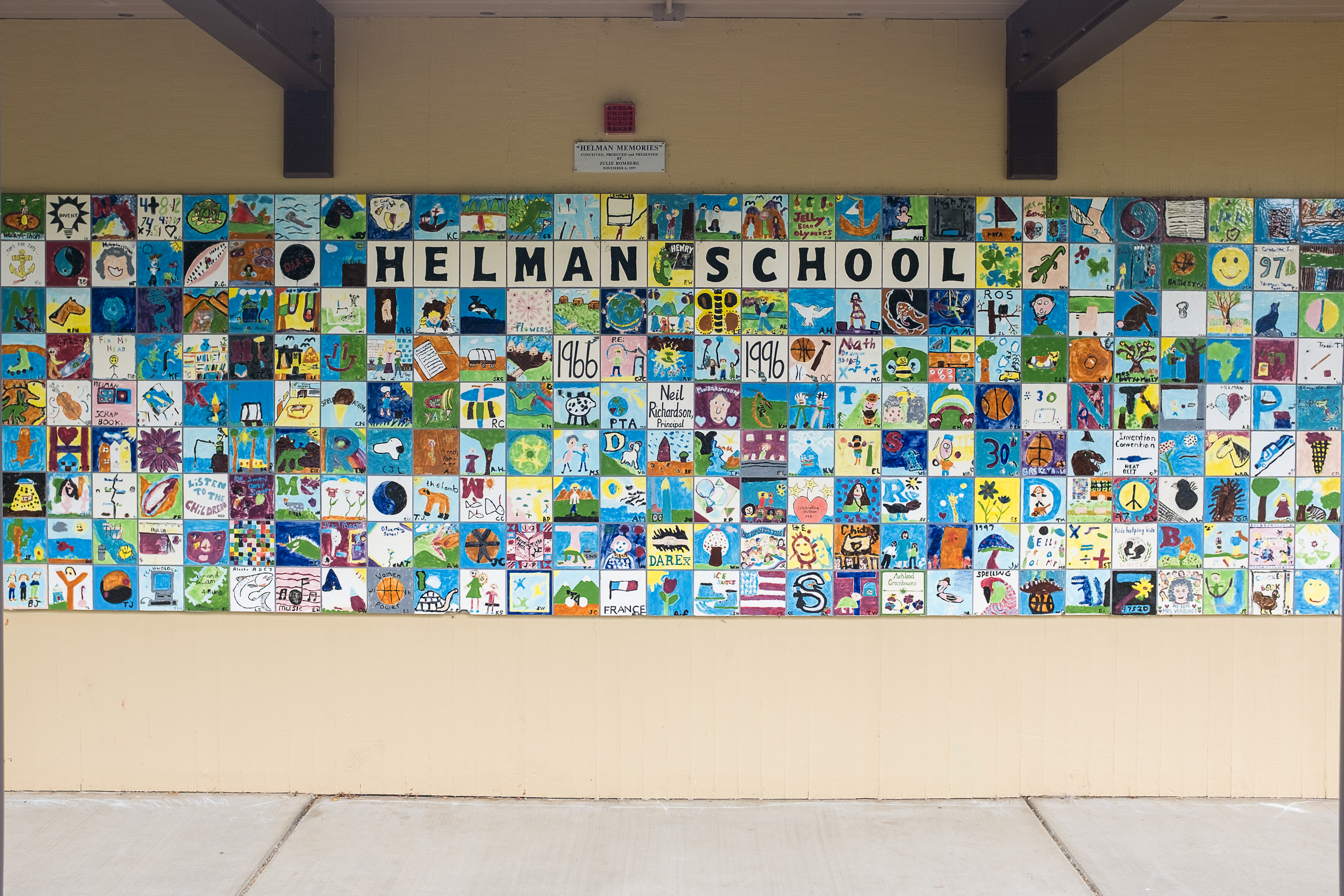 Artistic Expression at Helman School: A colorful mosaic of student-created tiles adorns the wall, each tile showcasing individual creativity and commemorating the vibrant spirit of Helman School.