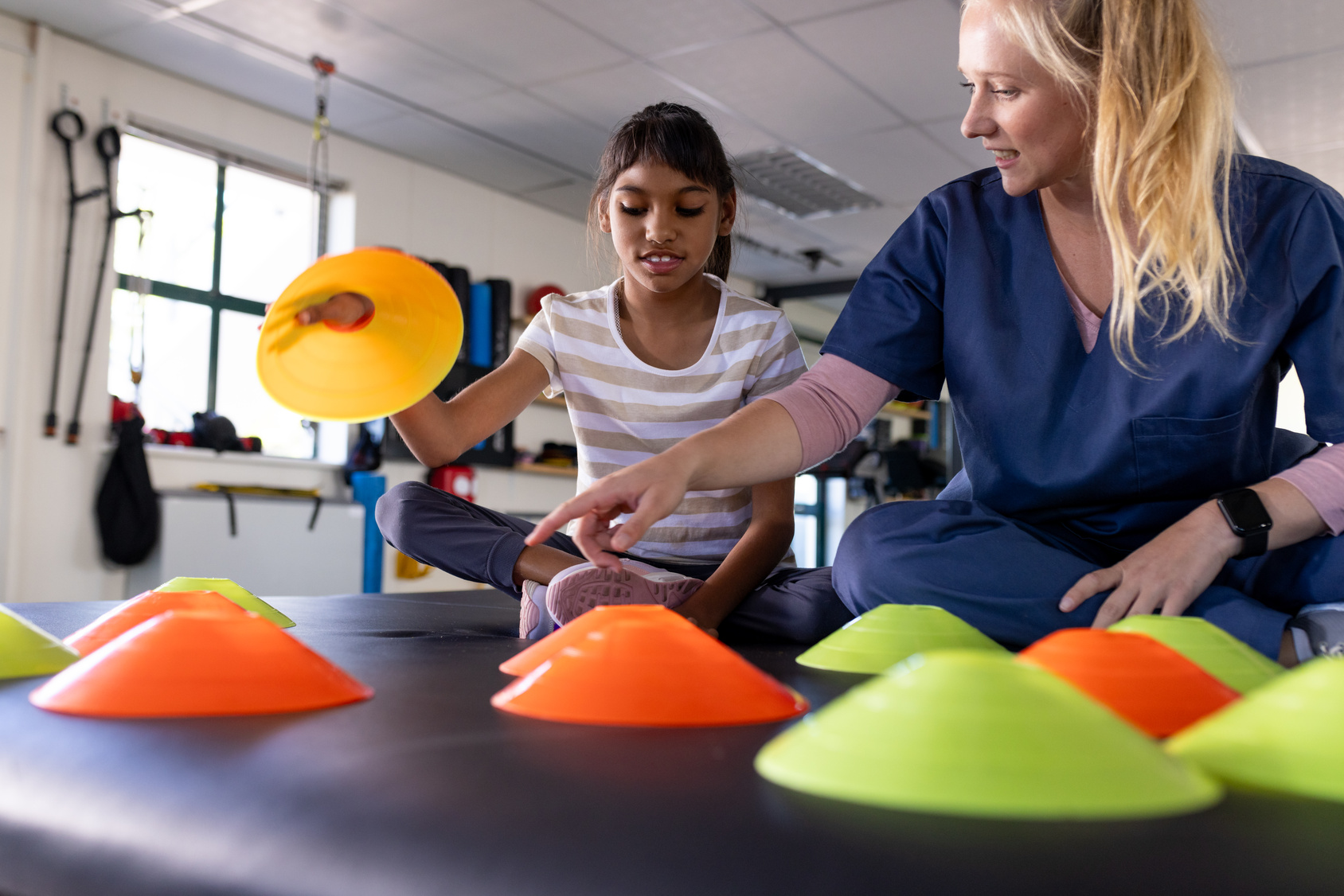 Occupational therapist stacking cones with a child