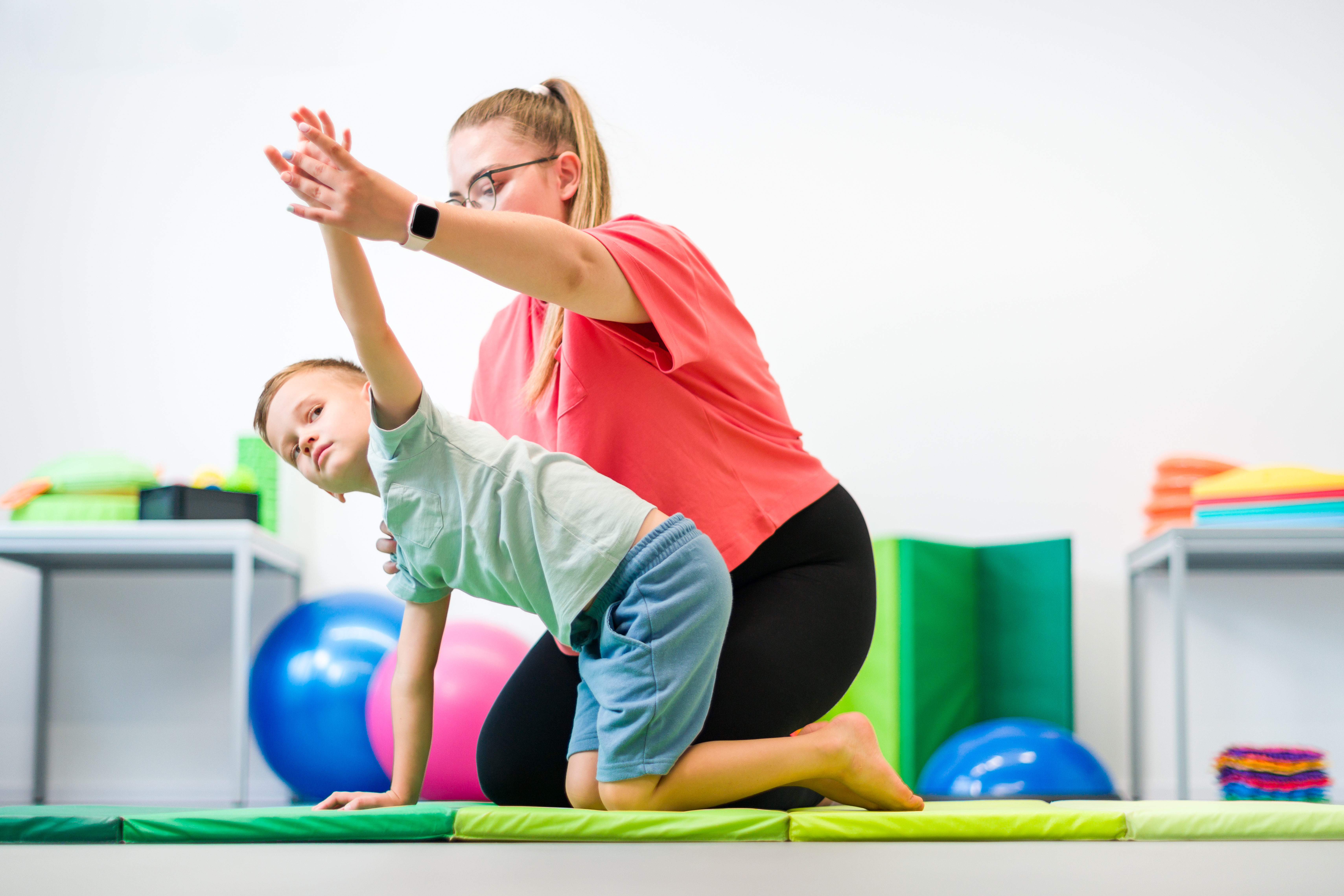 Physical therapist working with child