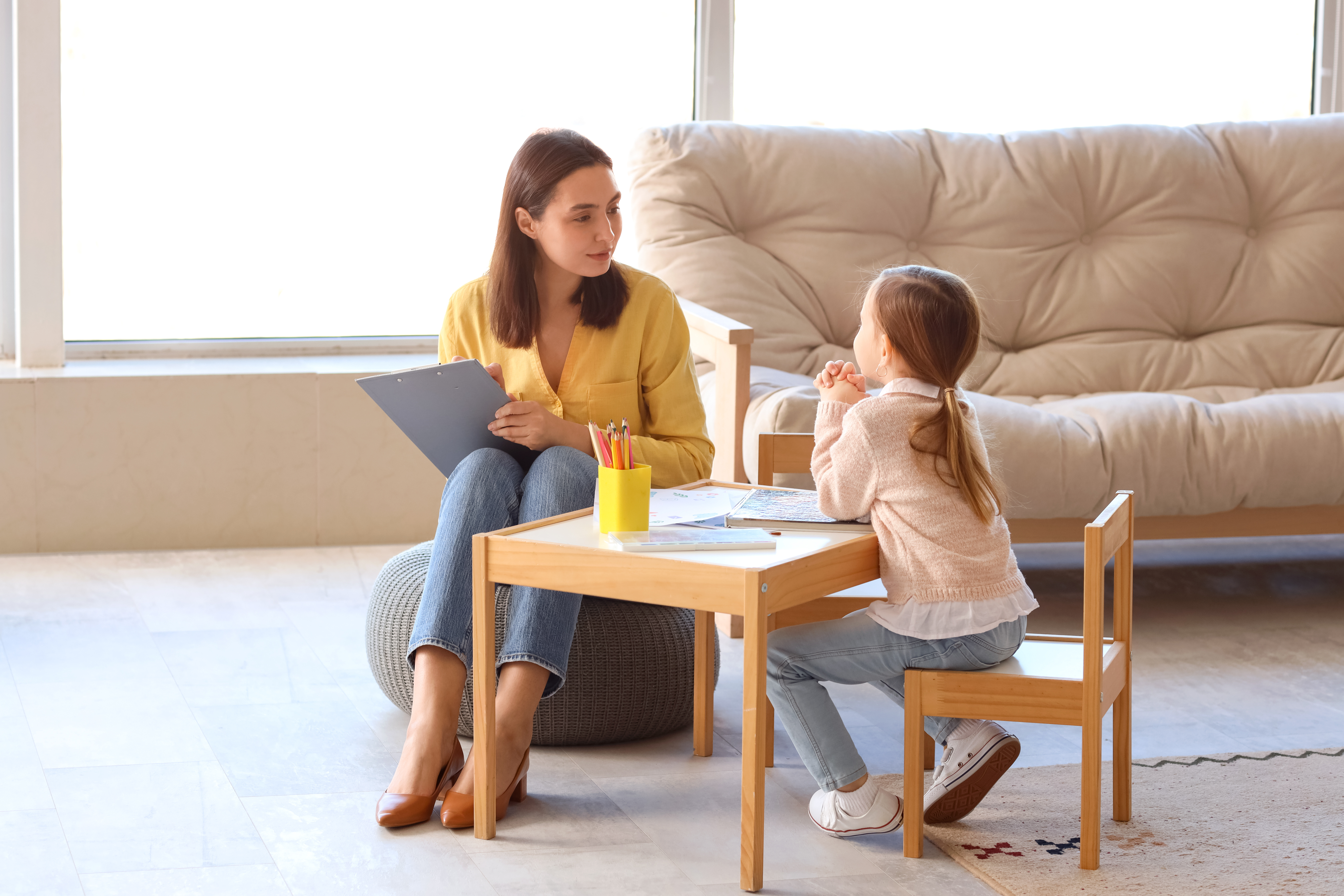 social worker and child in a therapy session