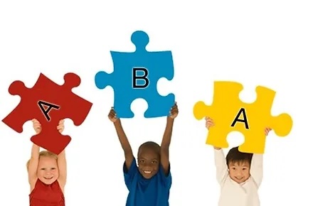 Kids holding puzzle pieces with ABA on them