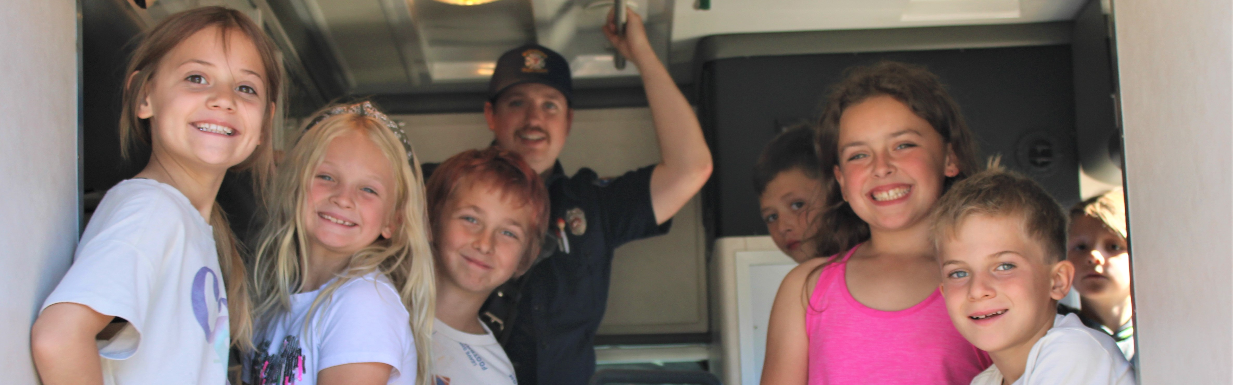 students in a KCFD#7 ambulance learning about safety 