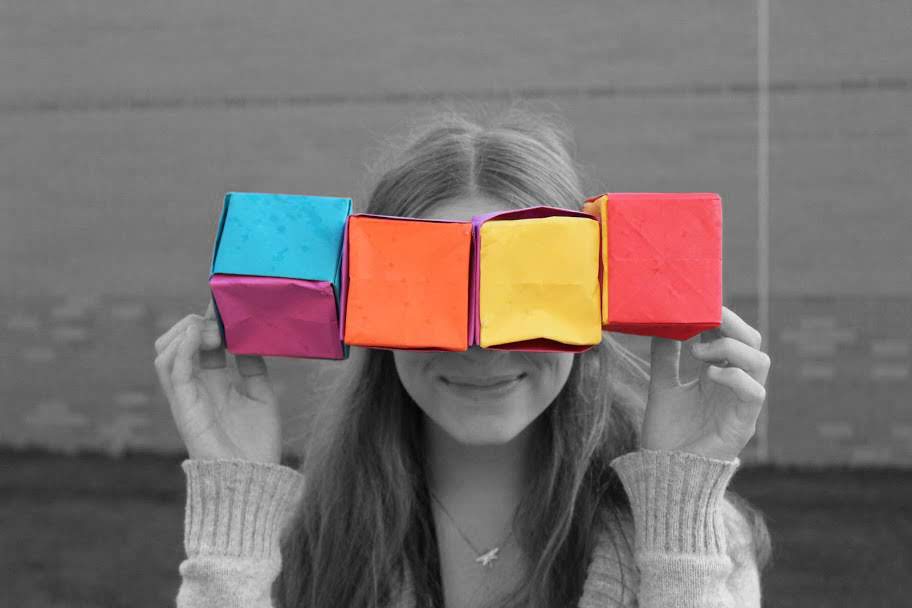 Intro to Photography Class Picture - Student holding Colorful Boxes