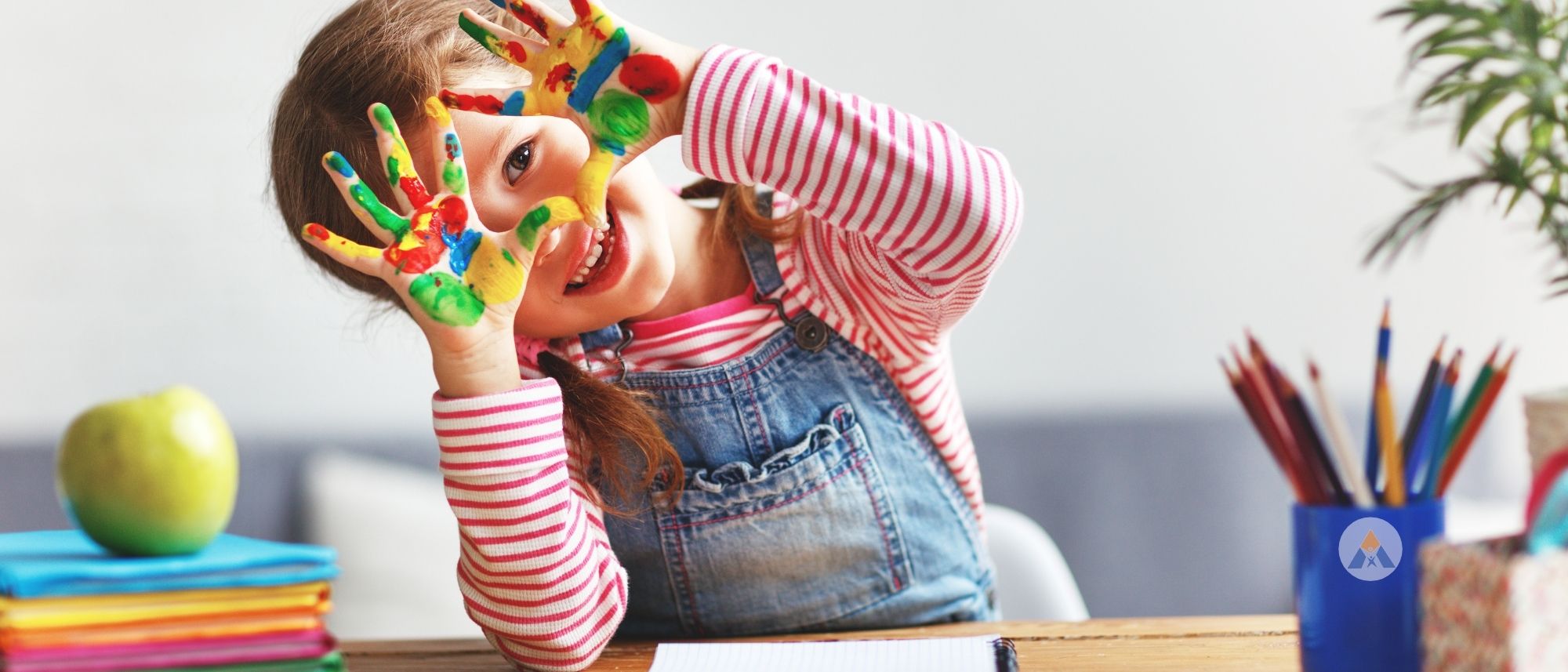 Picture of little girl holding up her painted fingers and smiling