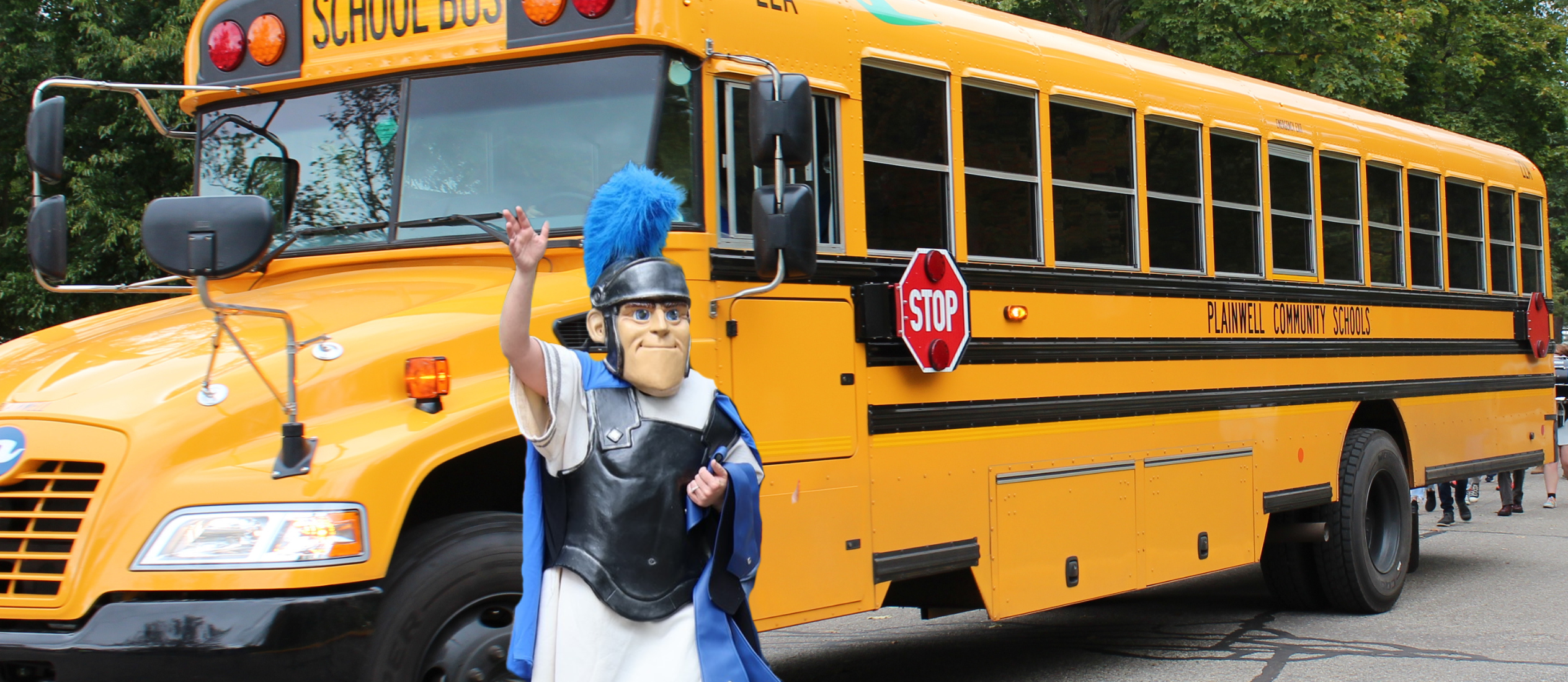 Picture of school bus with Trojan mascot