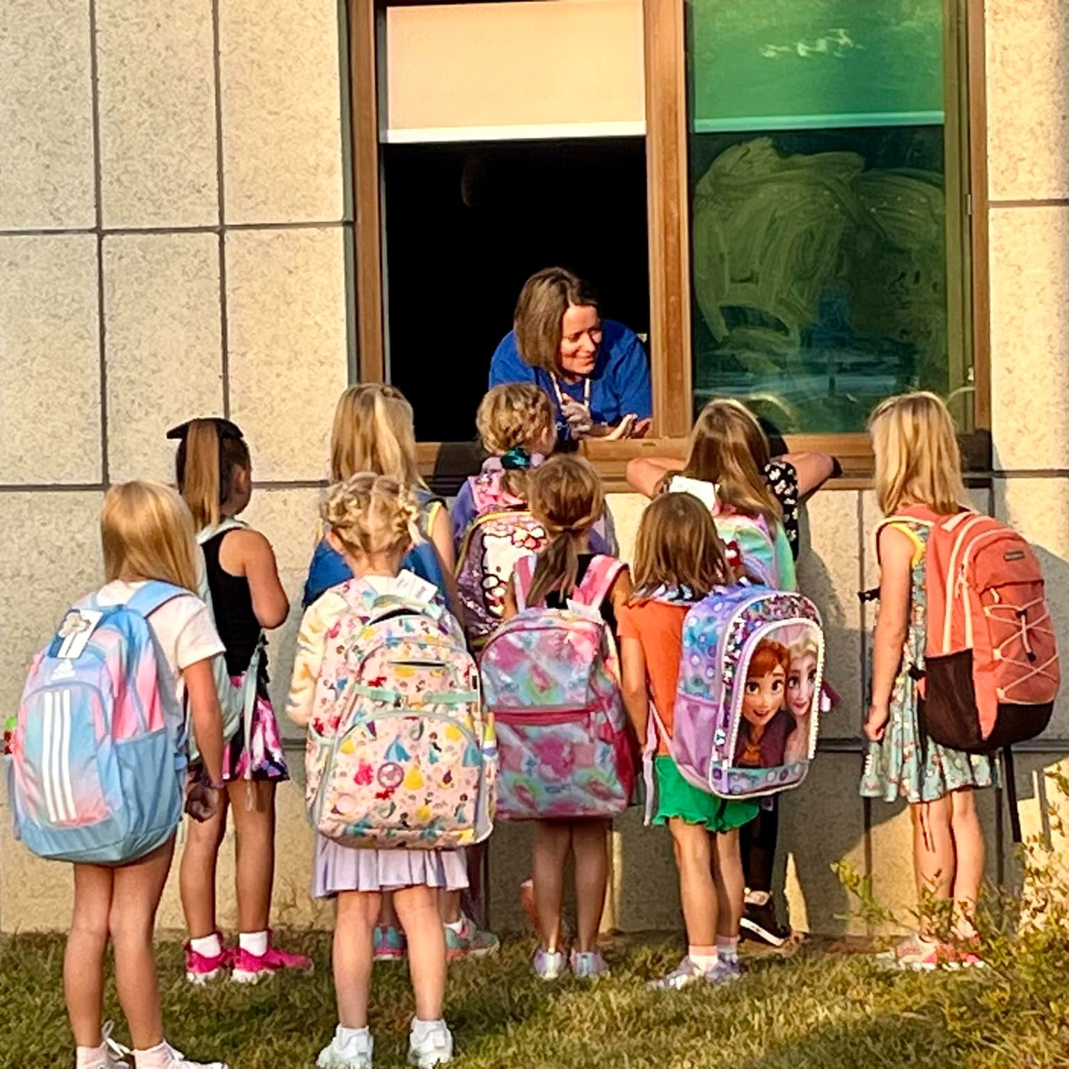 Picture of teacher talking to students outside a building
