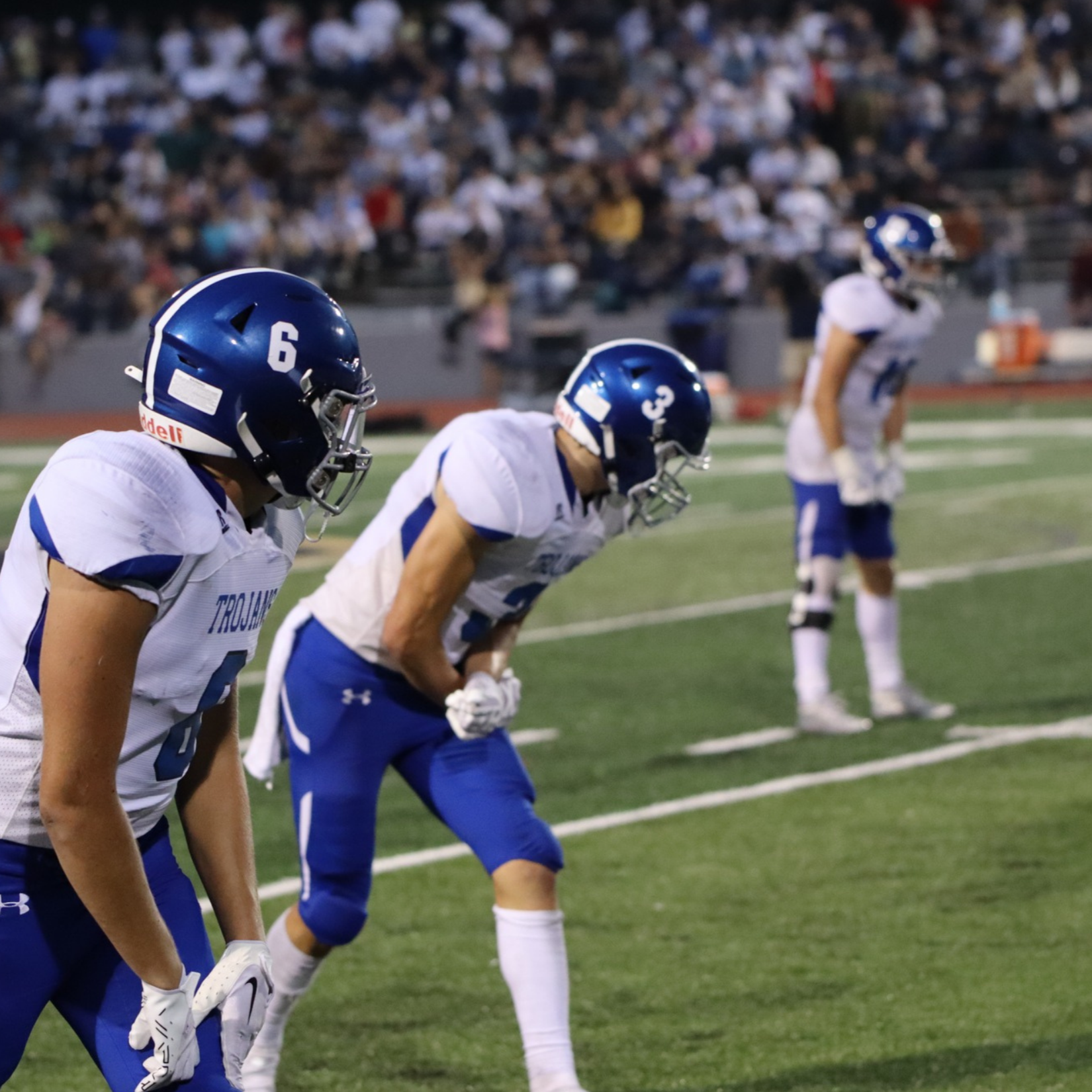 Picture of three trojan football players