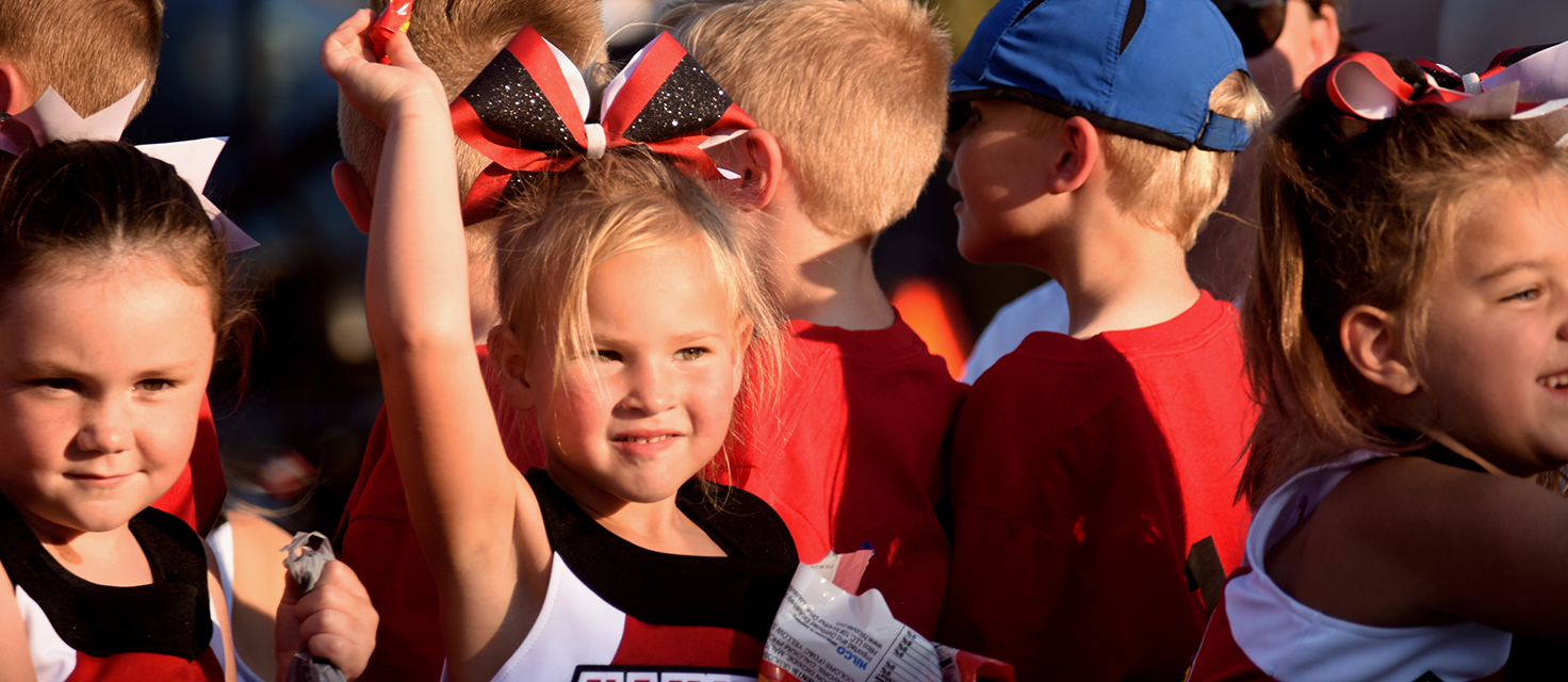 Young cheerleaders toss candy during the annual Melissa Homecoming Parade