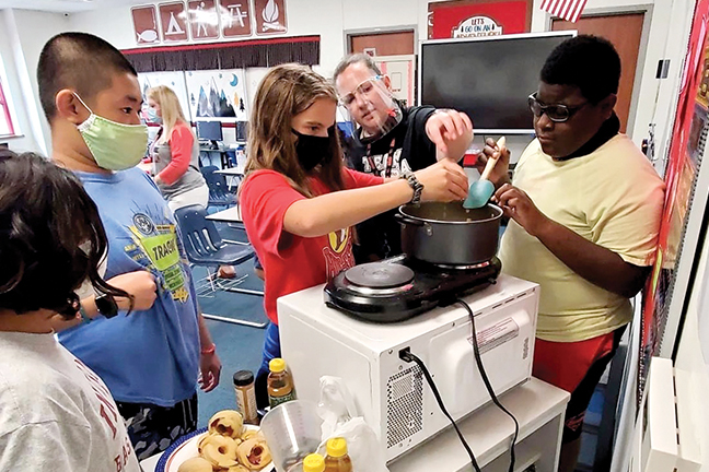 Students learn to cook using safety measures