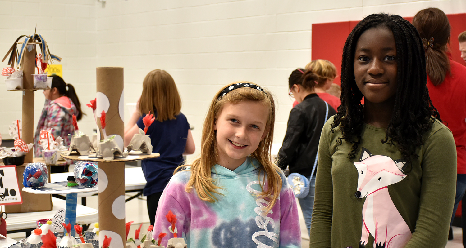 Two students pose for a picture by their GT projects at Melissa STREAM Night