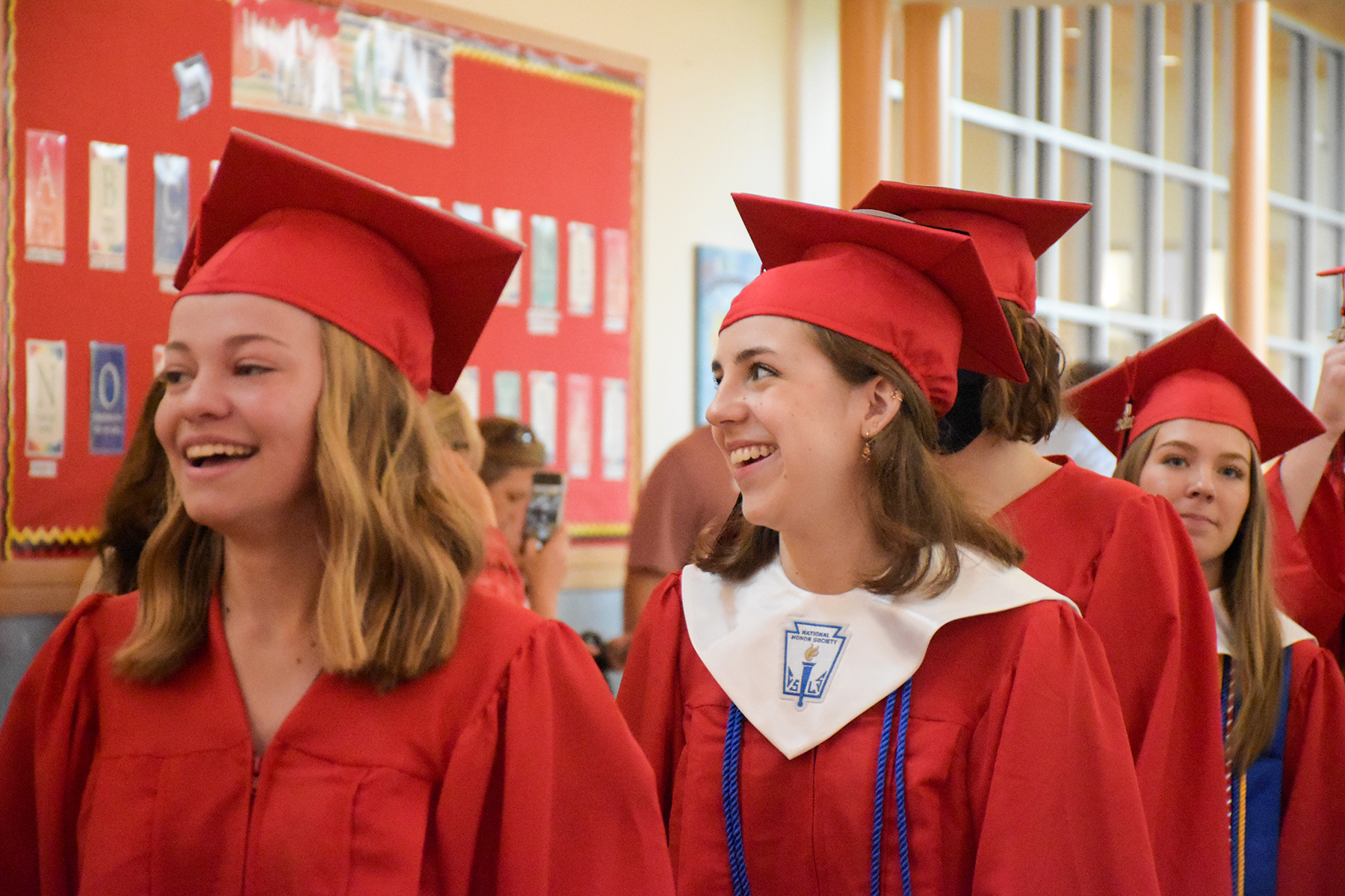 Students dressed in cap and gown participate in the Class of 2021 Senior Walk 