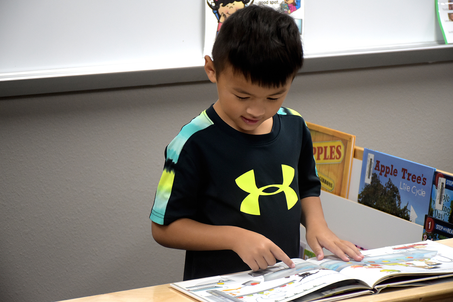 Pre-K student reads a book