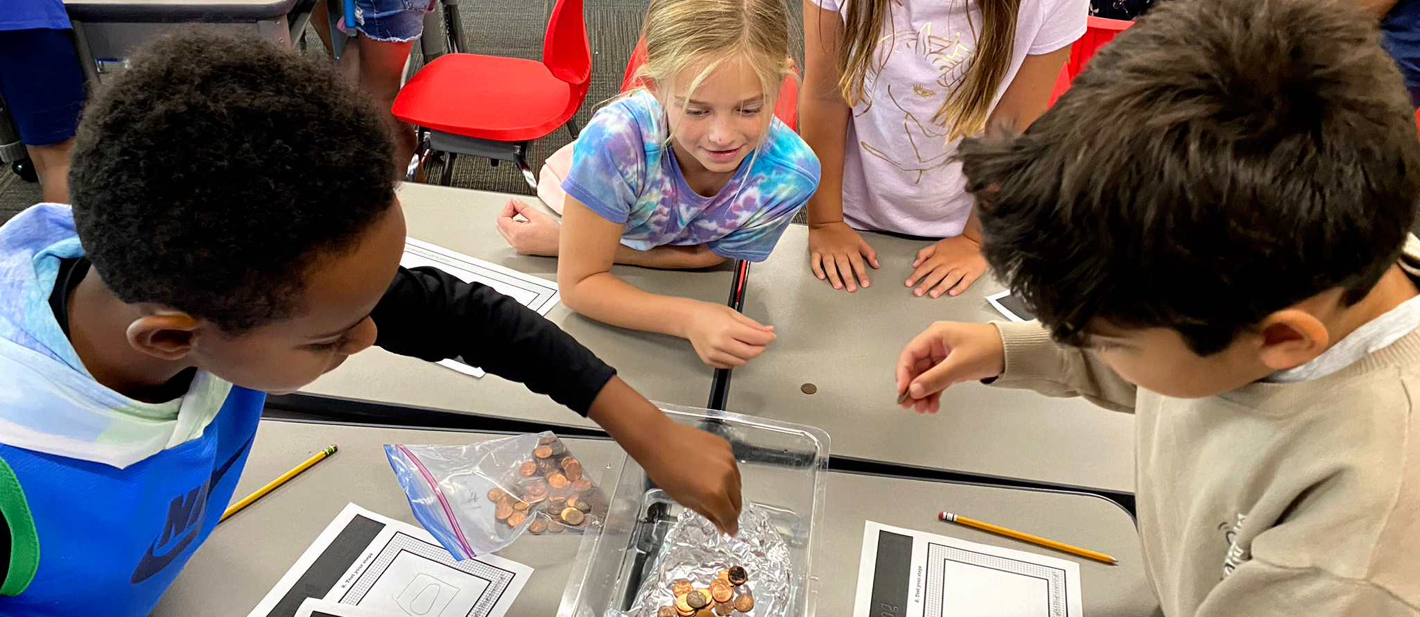 Sinking foil boats with pennies